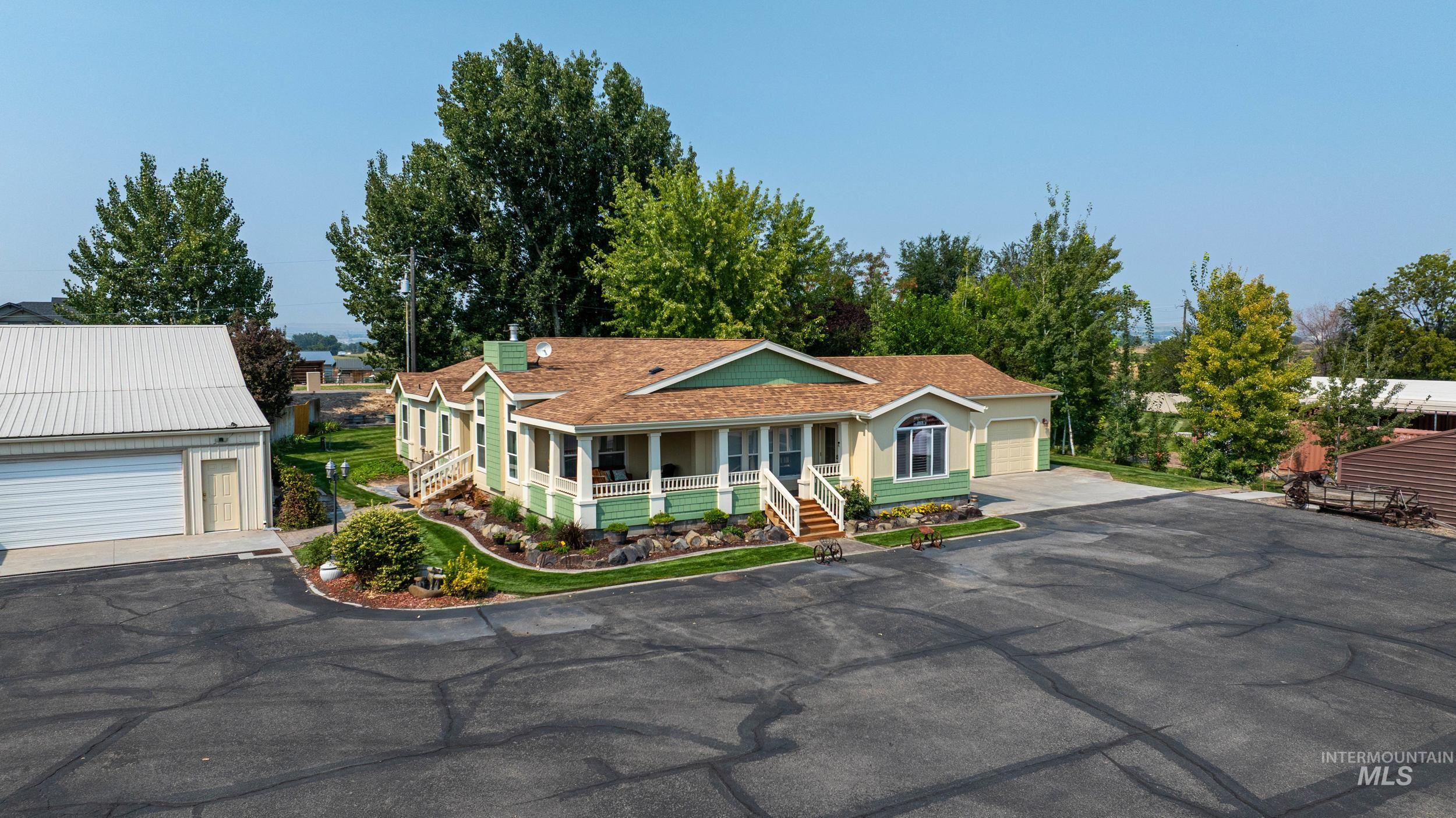 View of front of house featuring covered porch and a garage