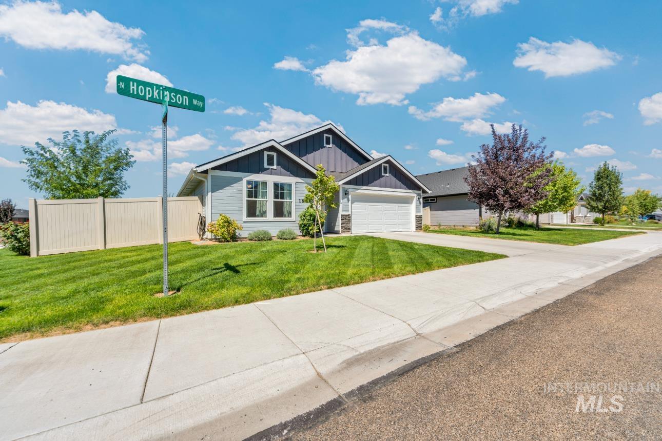 Craftsman-style house with board and batten siding, driveway, and an attached garage