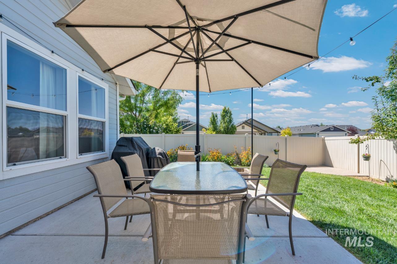 Fenced backyard featuring a patio area with area for grilling and 2nd patio