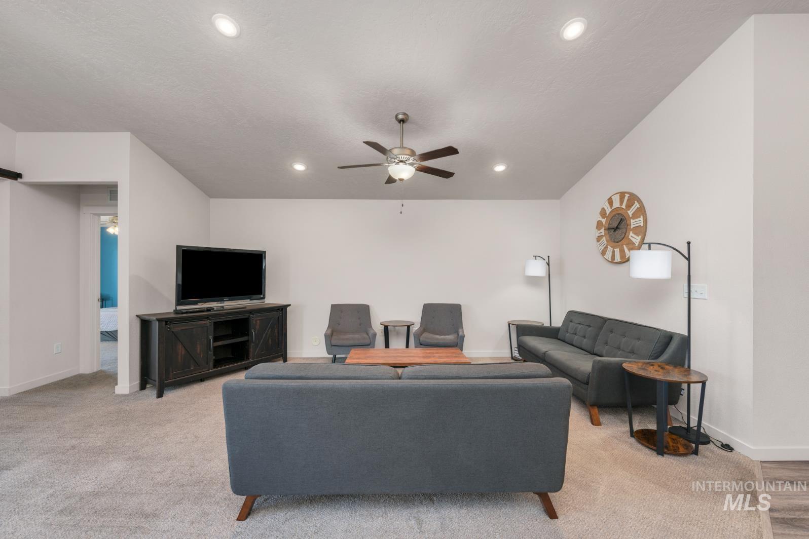 Living room with recessed lighting and ceiling fan
