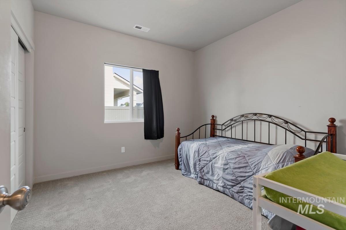 Bedroom featuring carpet and a closet