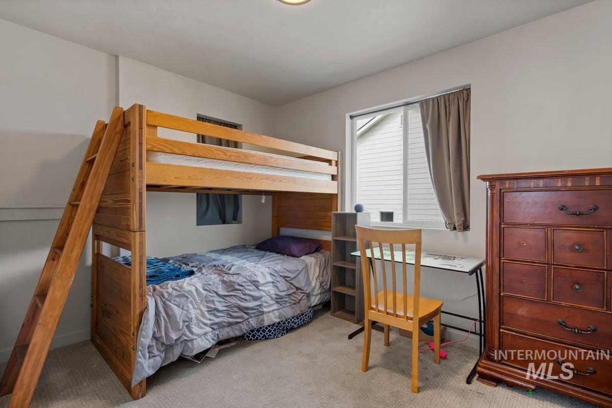 Bedroom featuring light colored carpet
