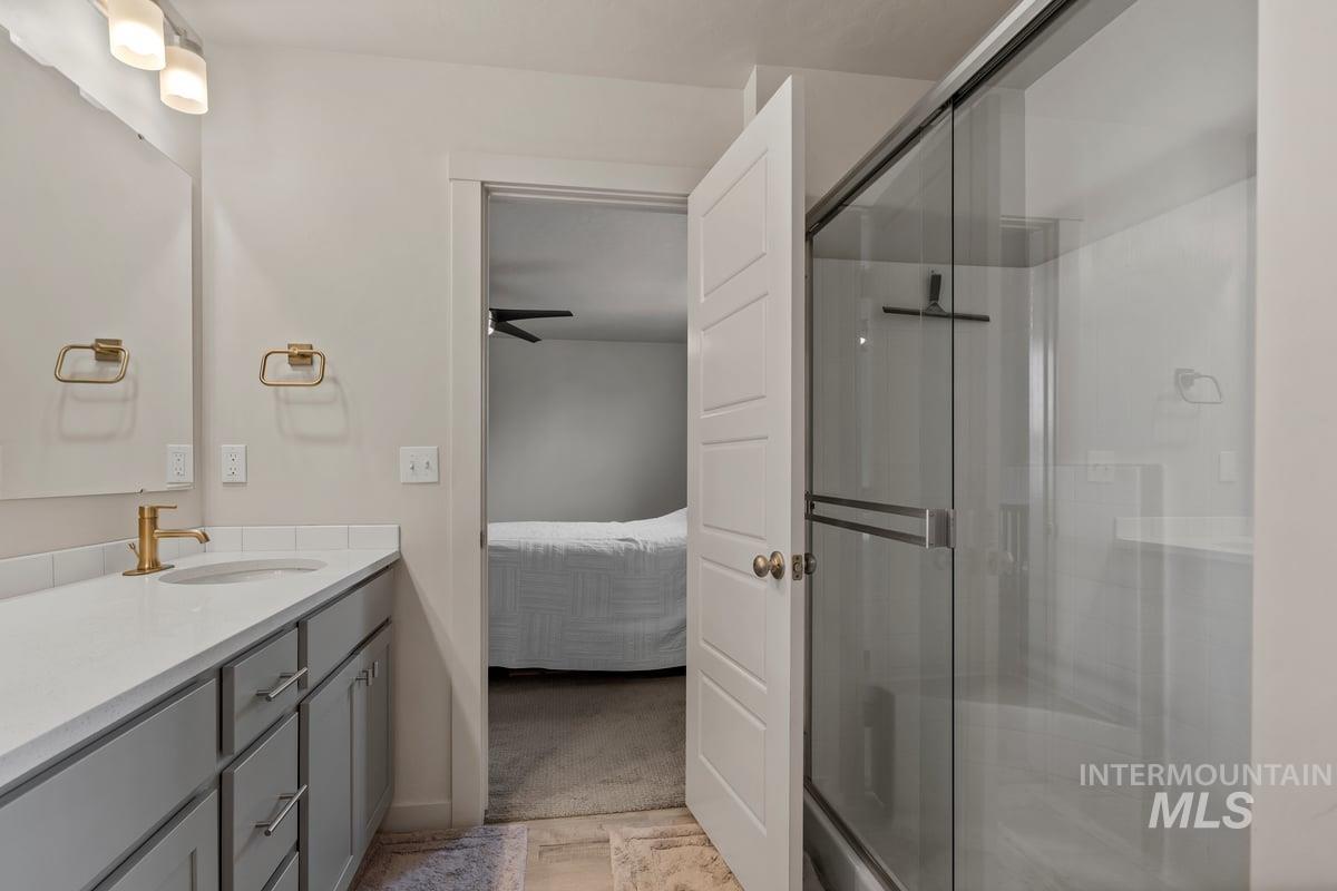 Ensuite bathroom featuring vanity and a stall shower