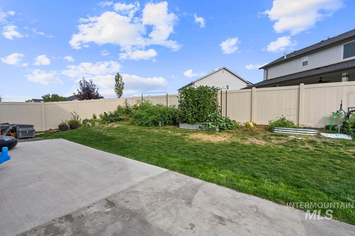 Fenced backyard with a patio area