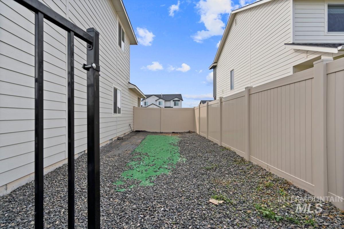 View of fenced backyard