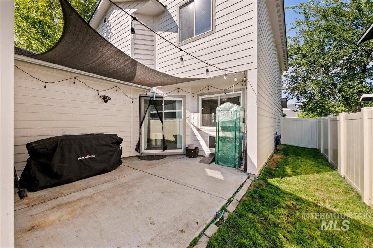 Fenced backyard featuring a patio