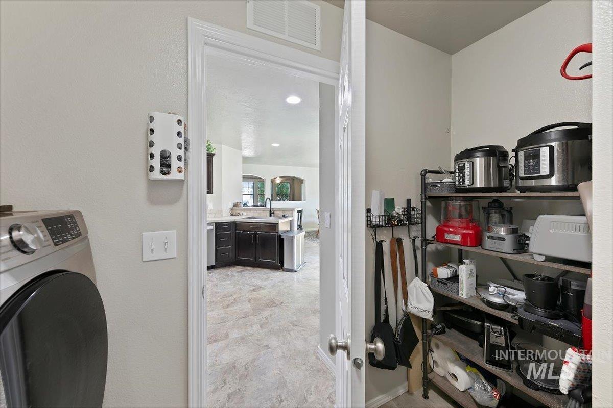 Washroom featuring washer / dryer and arched walkways