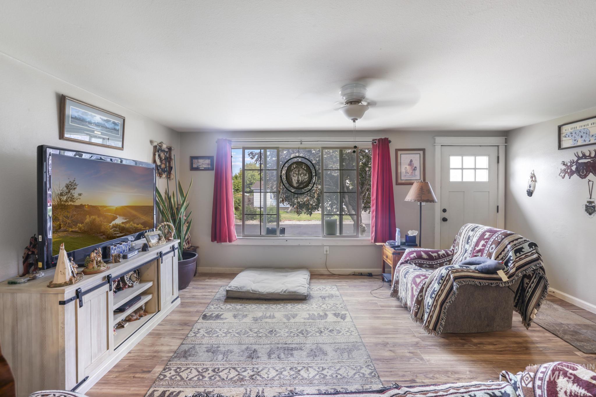 Living area with wood finished floors and a ceiling fan