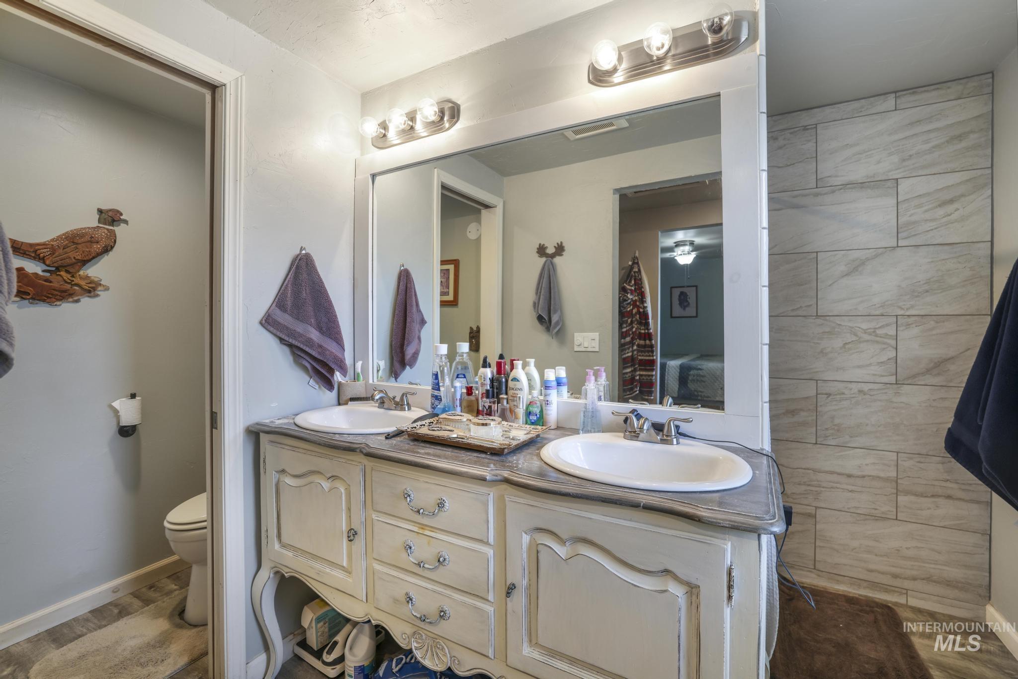 Full bath with double vanity and ensuite bath