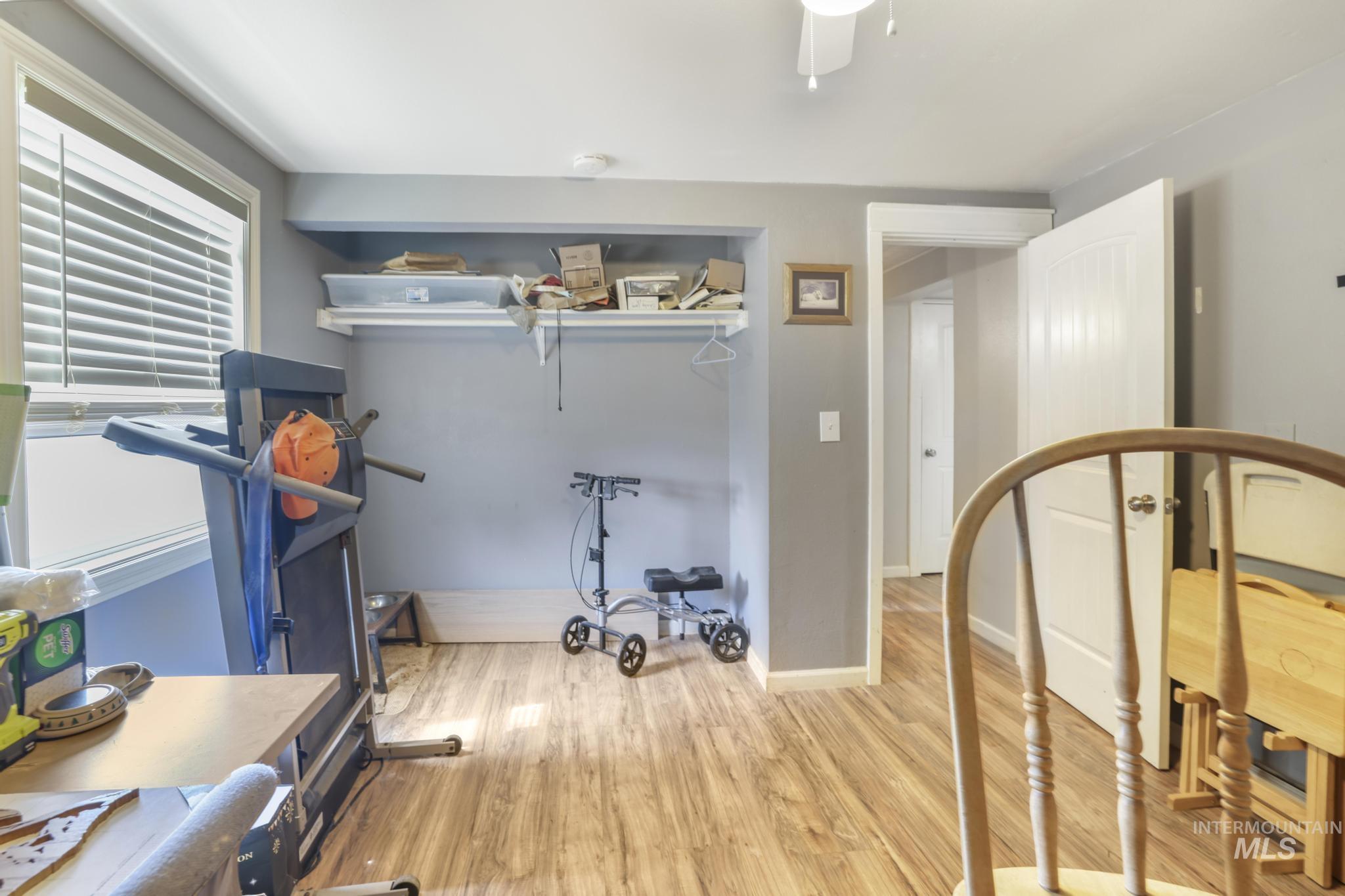 Workout room with wood finished floors and baseboards