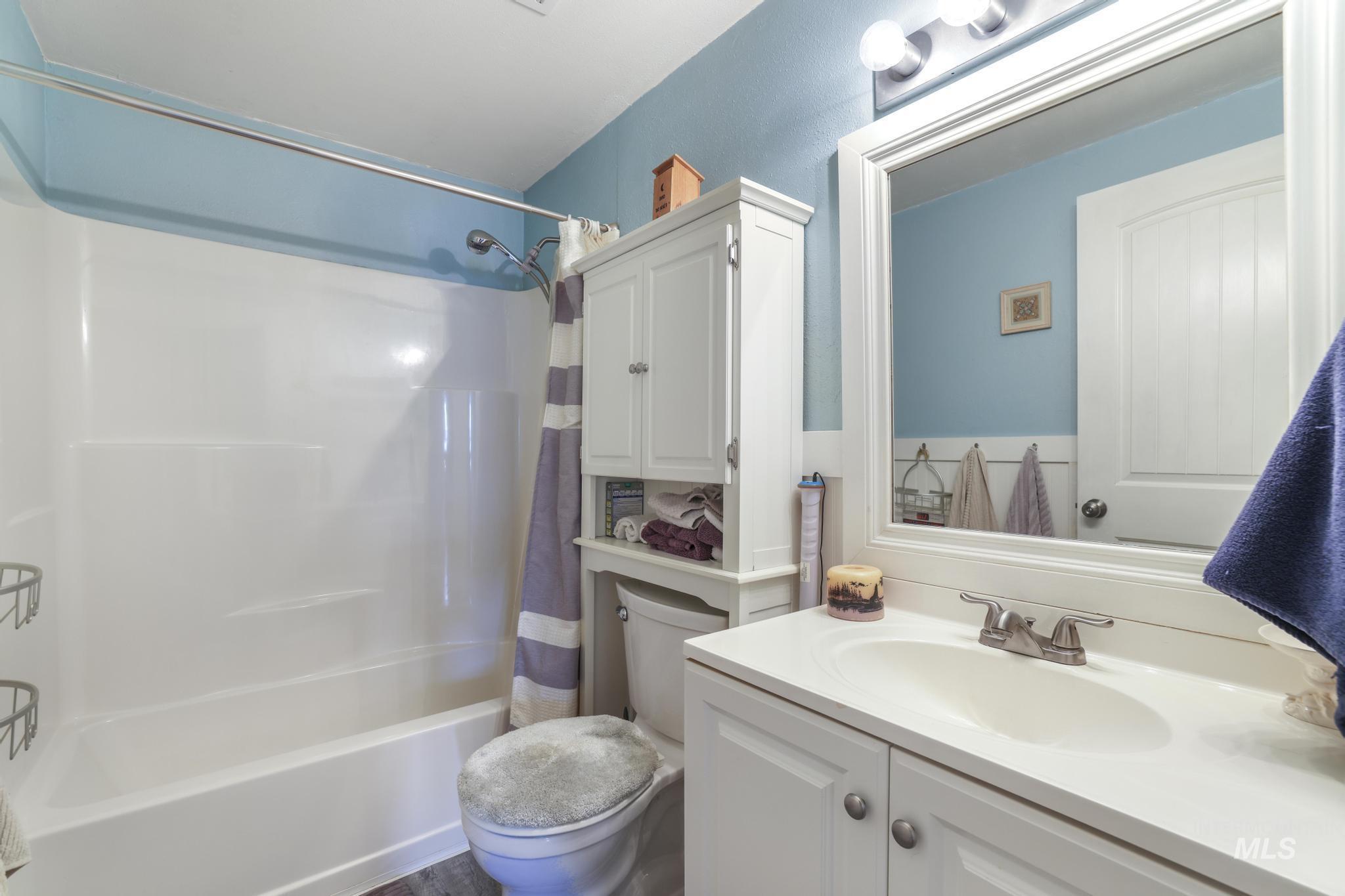 Bathroom featuring shower / bath combo and vanity