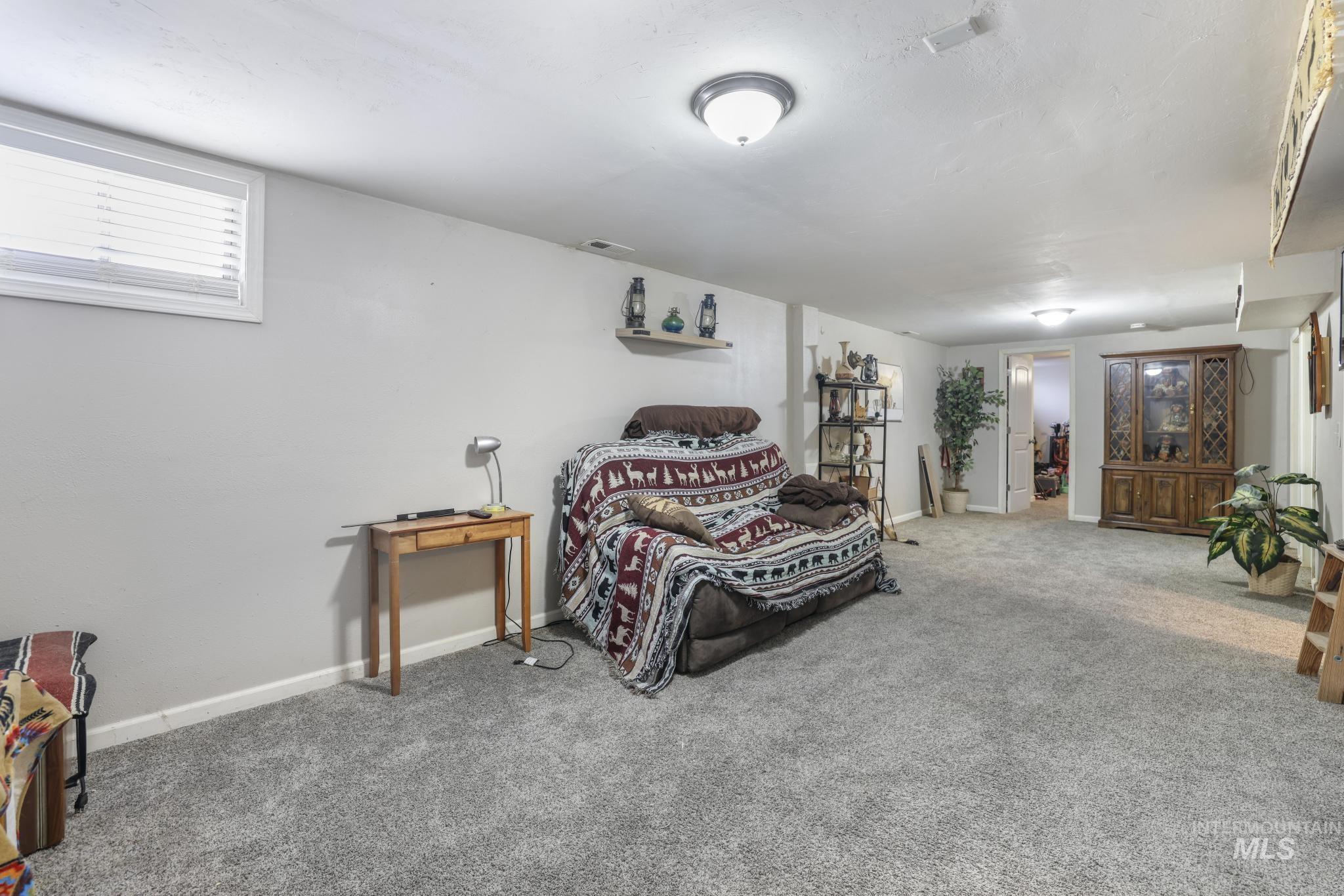 Bedroom featuring carpet flooring and baseboards