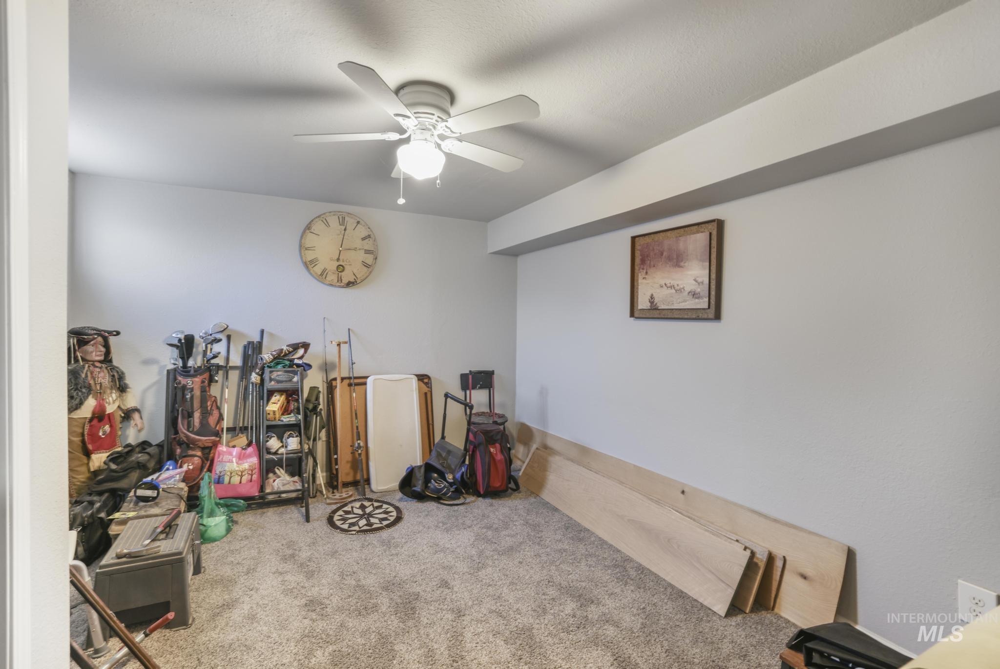 Rec room with carpet floors and ceiling fan