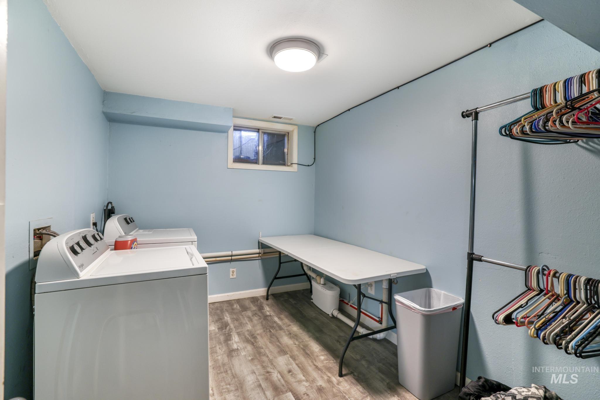 Washroom featuring light wood finished floors and independent washer and dryer