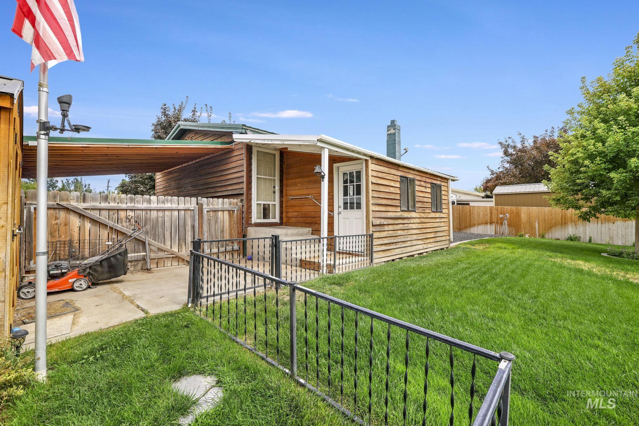 View of front of house featuring a fenced backyard and a chimney