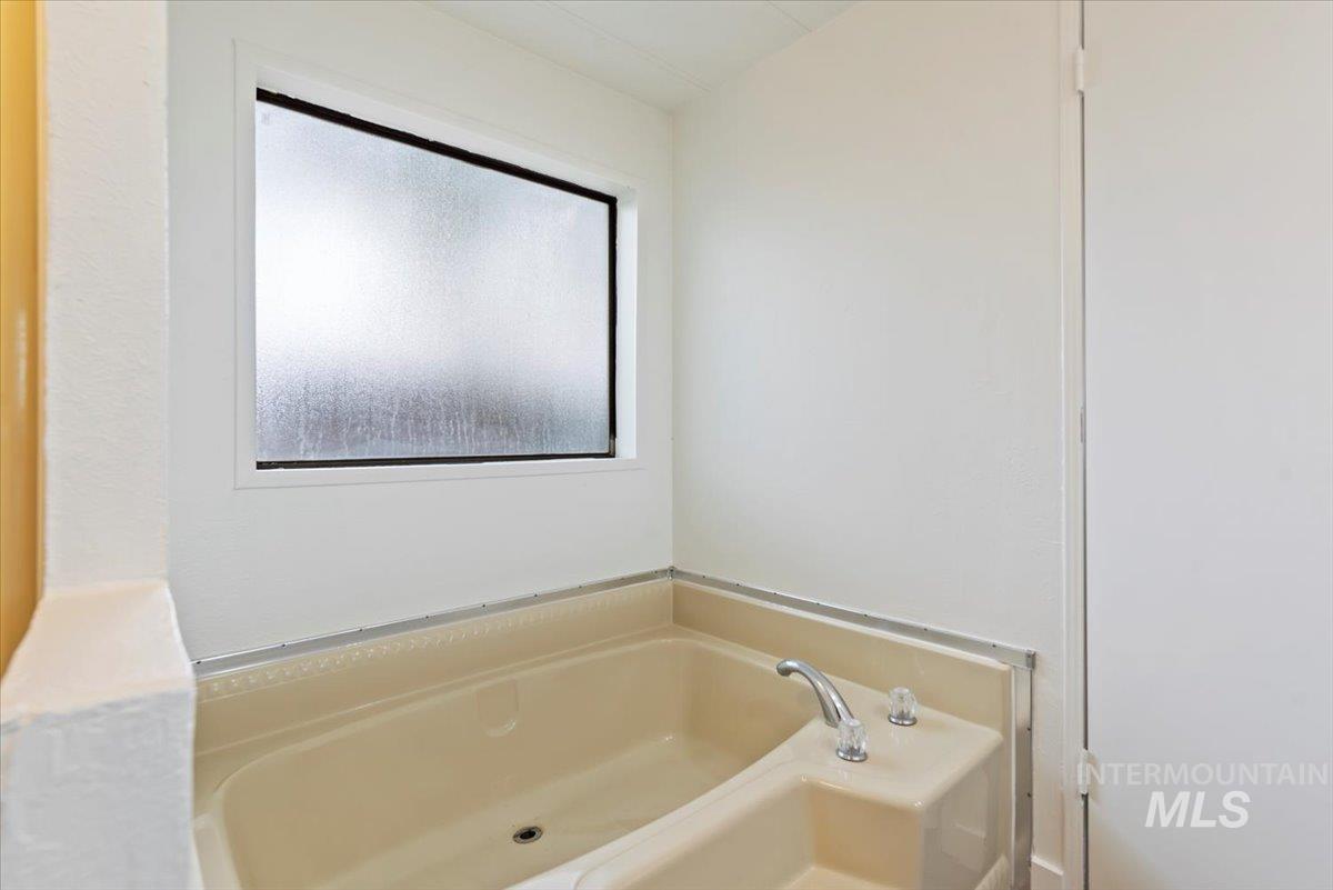 Full bath featuring a bath