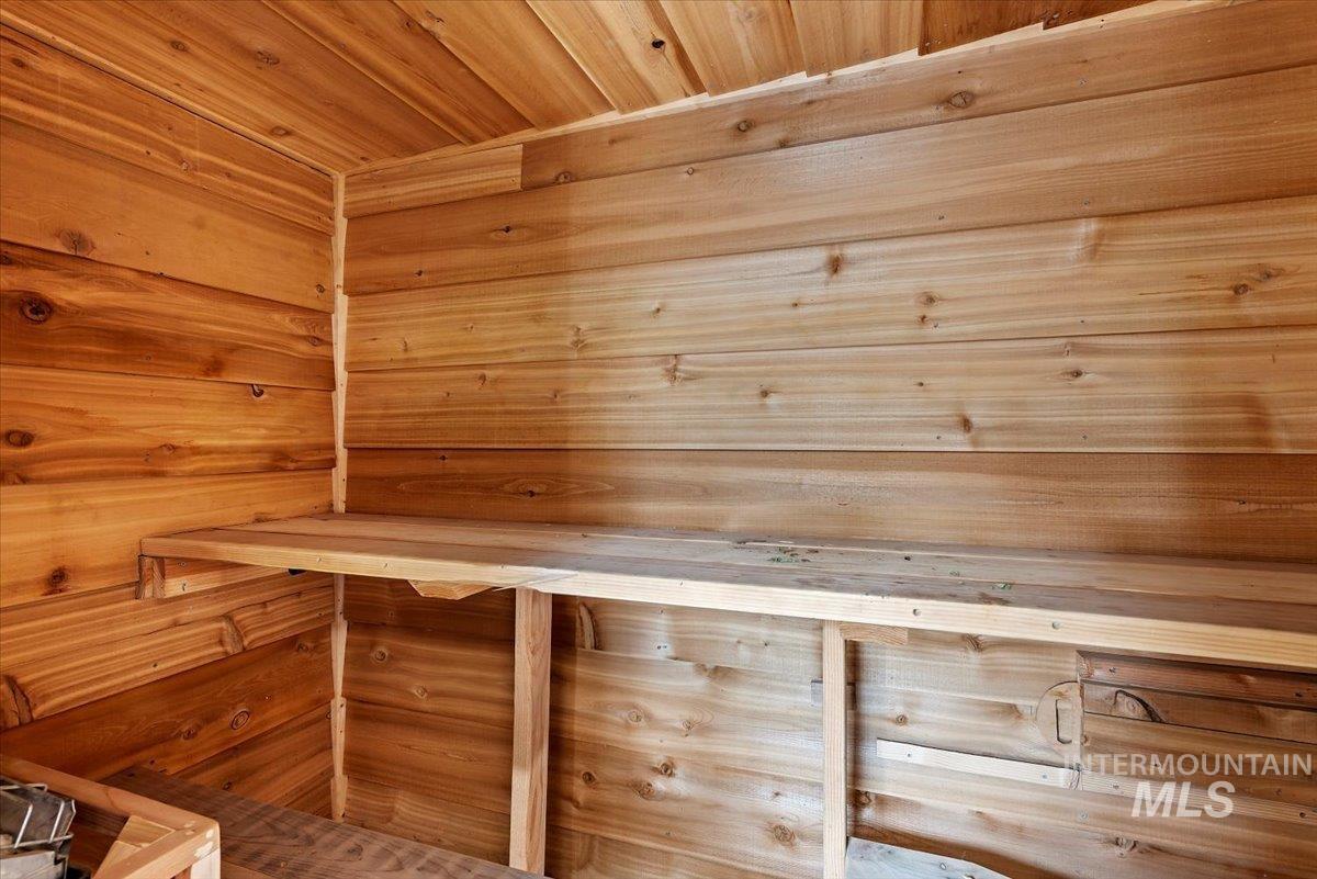 Sauna featuring wood ceiling and wood walls