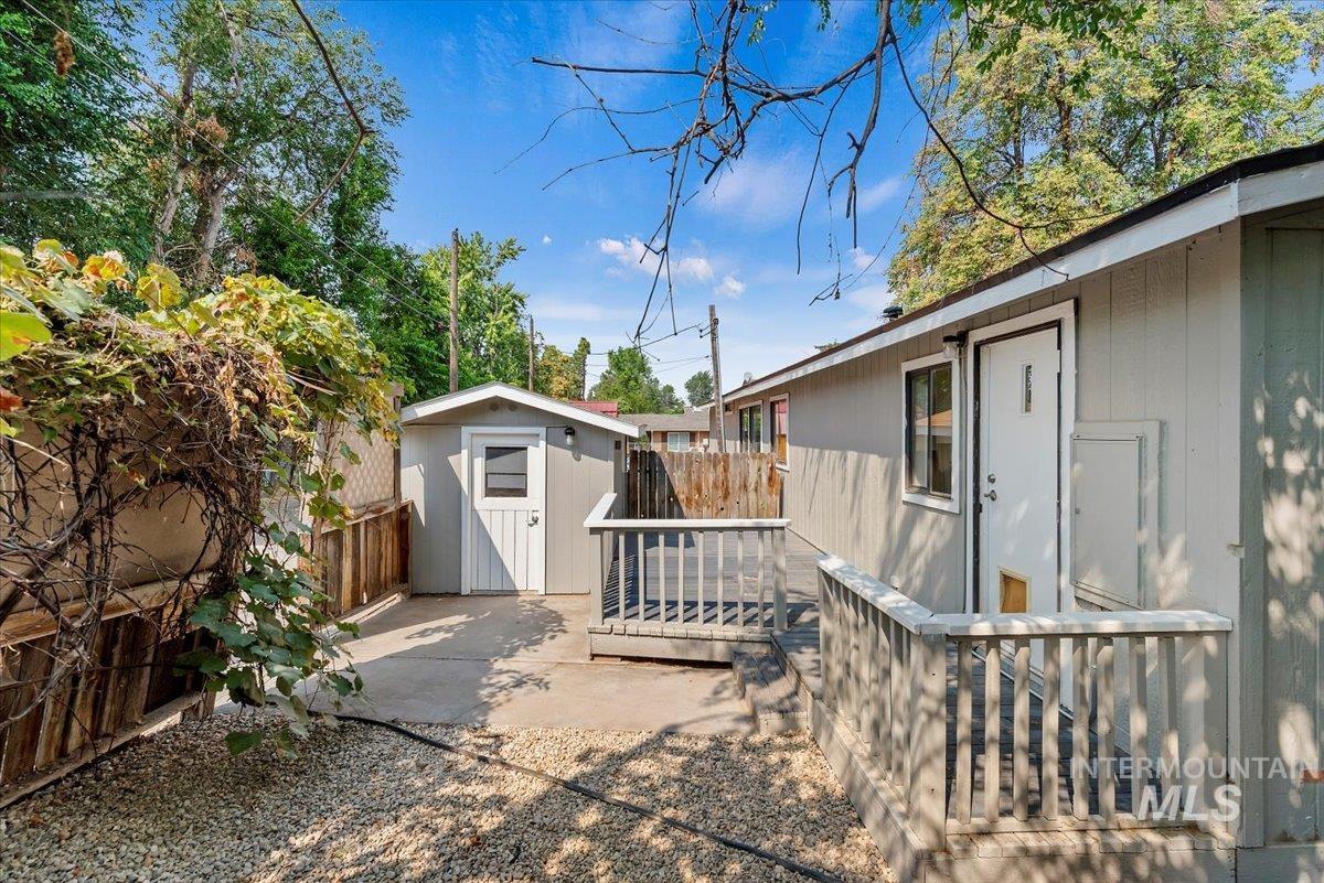 Exterior space with a storage shed and a deck