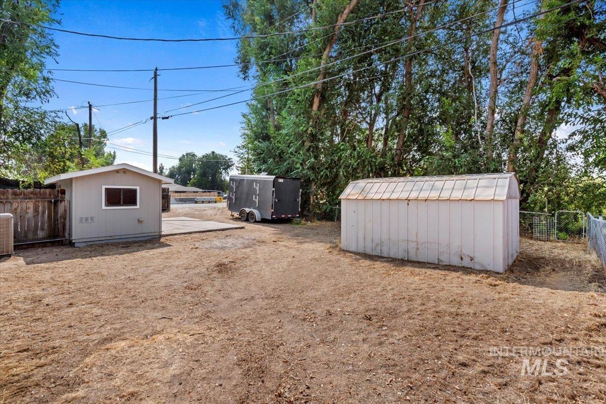 View of yard with a storage unit