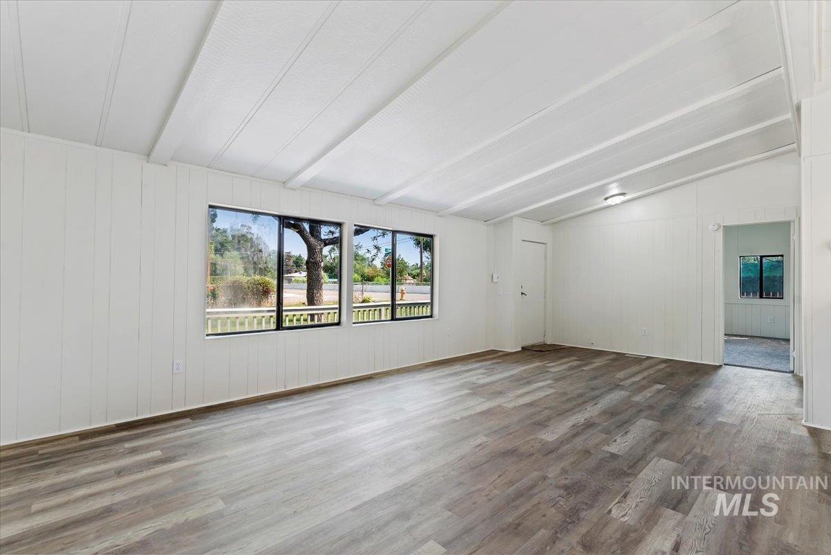 Spare room with wood finished floors and wooden walls