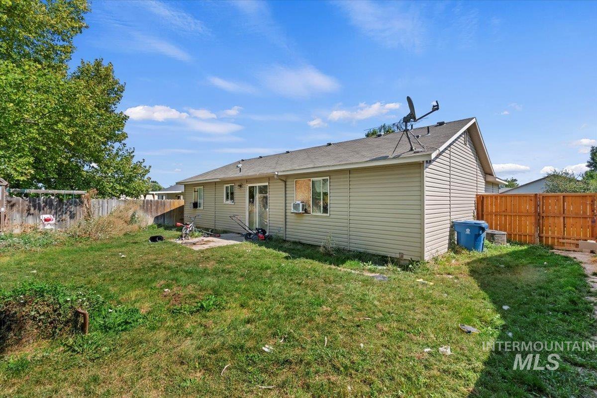 Back of property with a fenced backyard and a patio