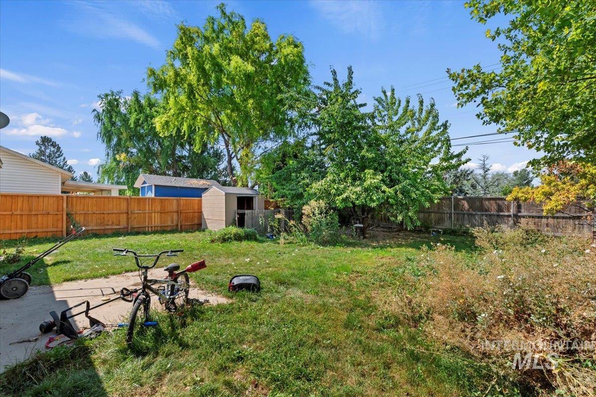 Fenced backyard with a storage unit