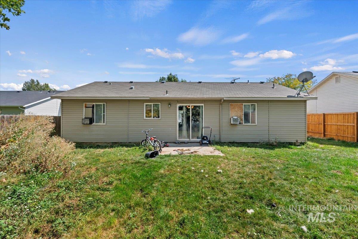 Rear view of property with a patio and a shingled roof