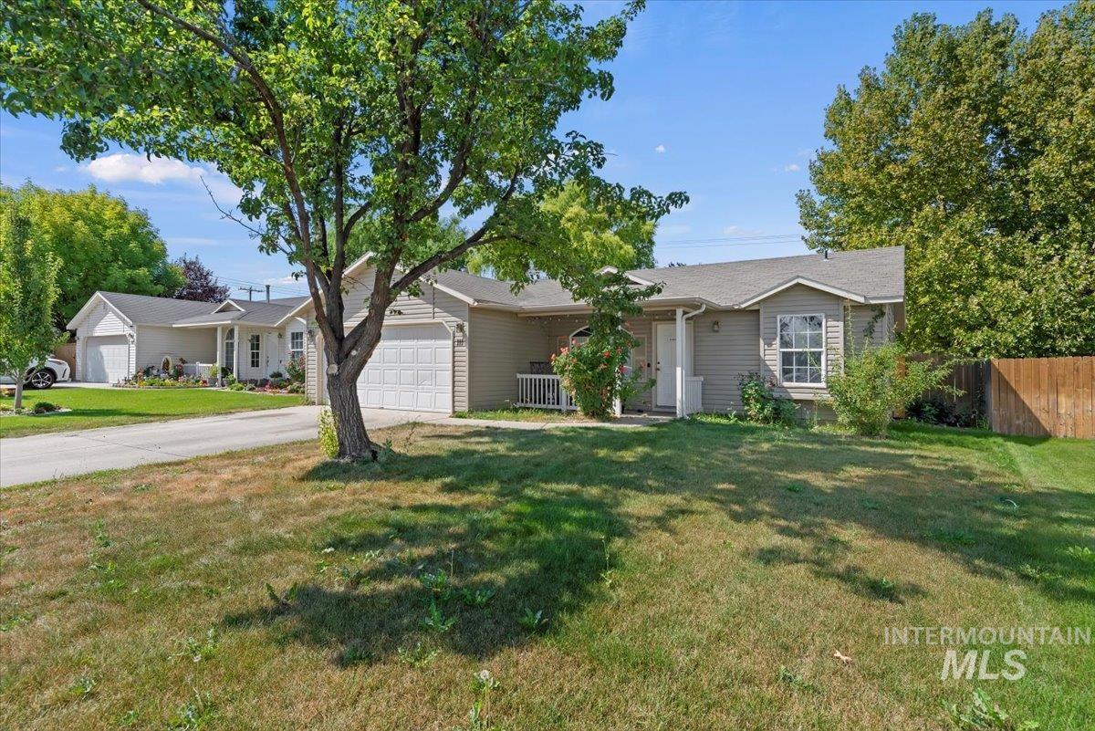 Ranch-style home featuring concrete driveway and an attached garage