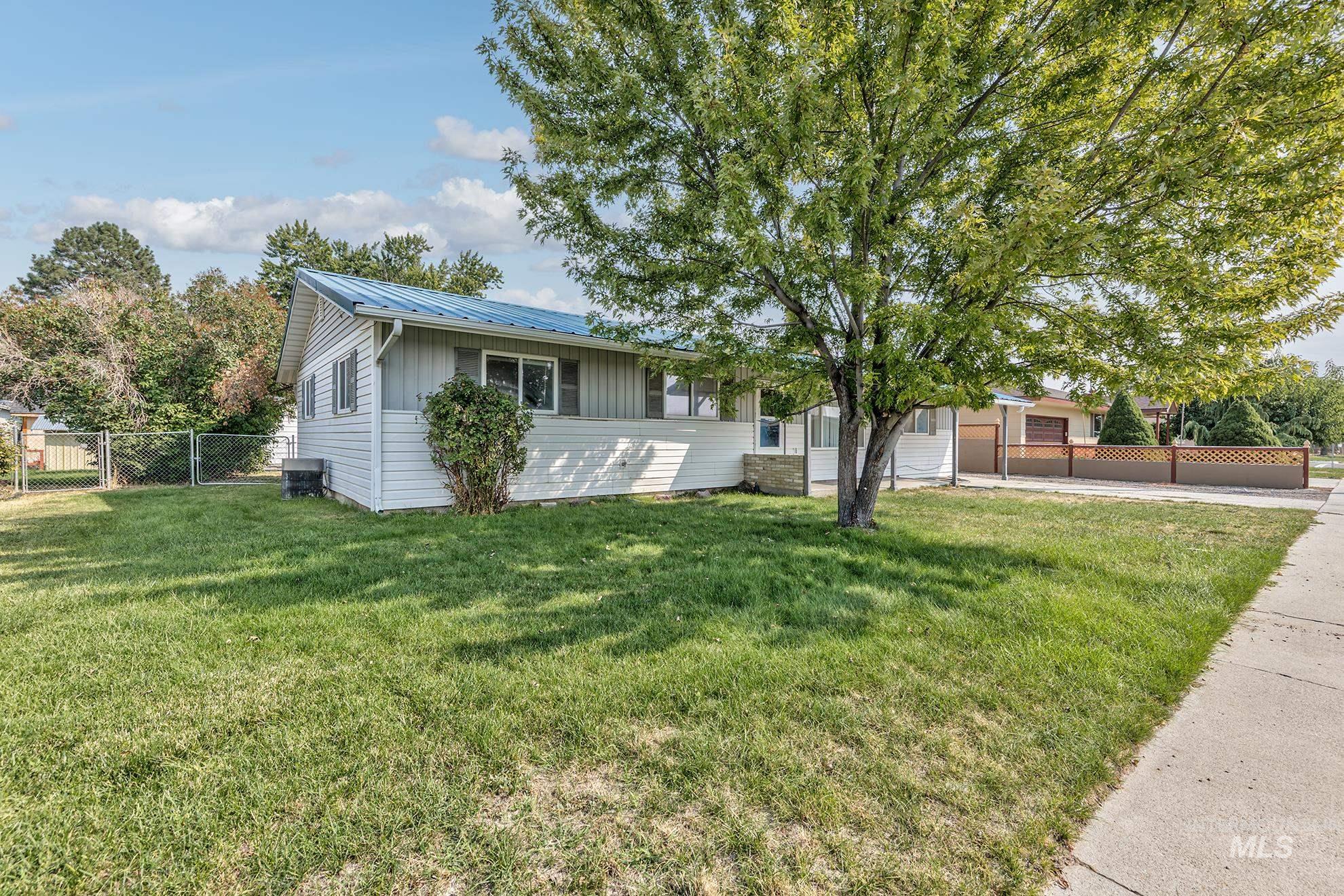 Single story home with a metal roof and board and batten siding