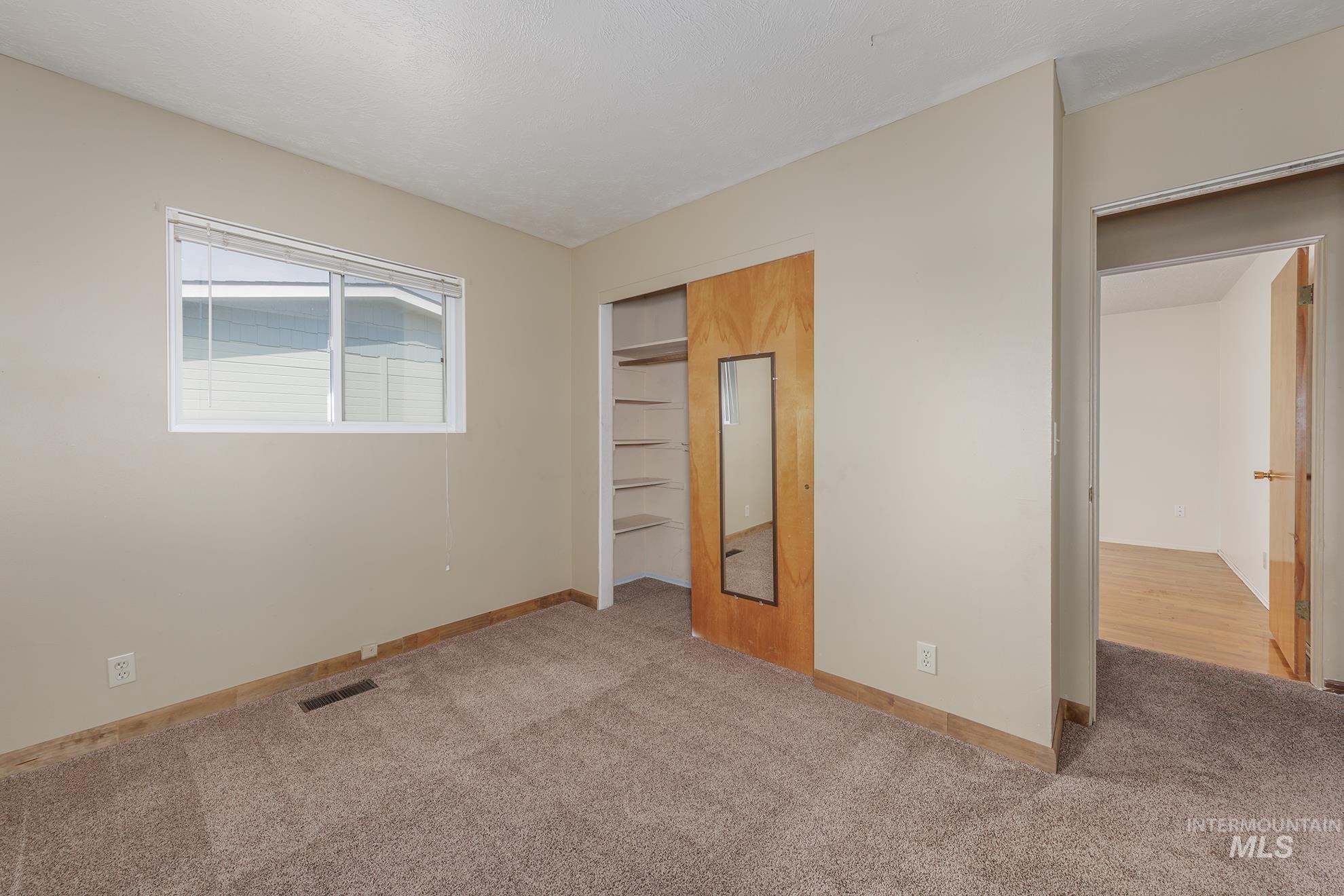 Unfurnished bedroom with carpet floors and a closet