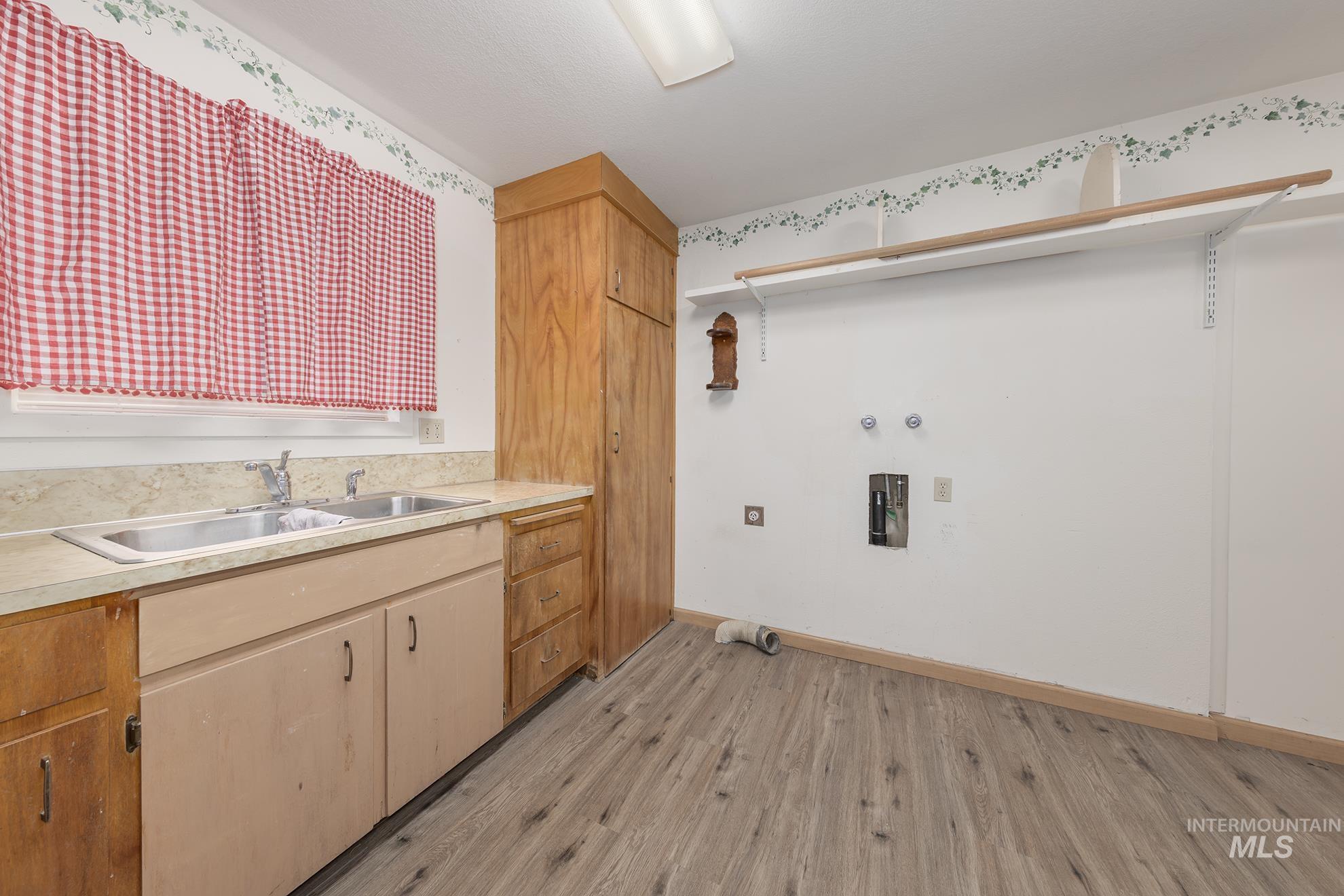 Laundry room with light wood finished floors, washer hookup, and gas dryer hookup