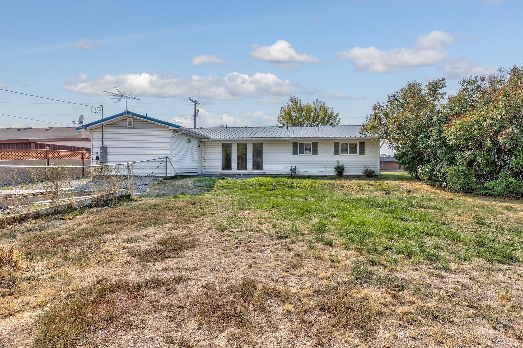 Rear view of property with a metal roof
