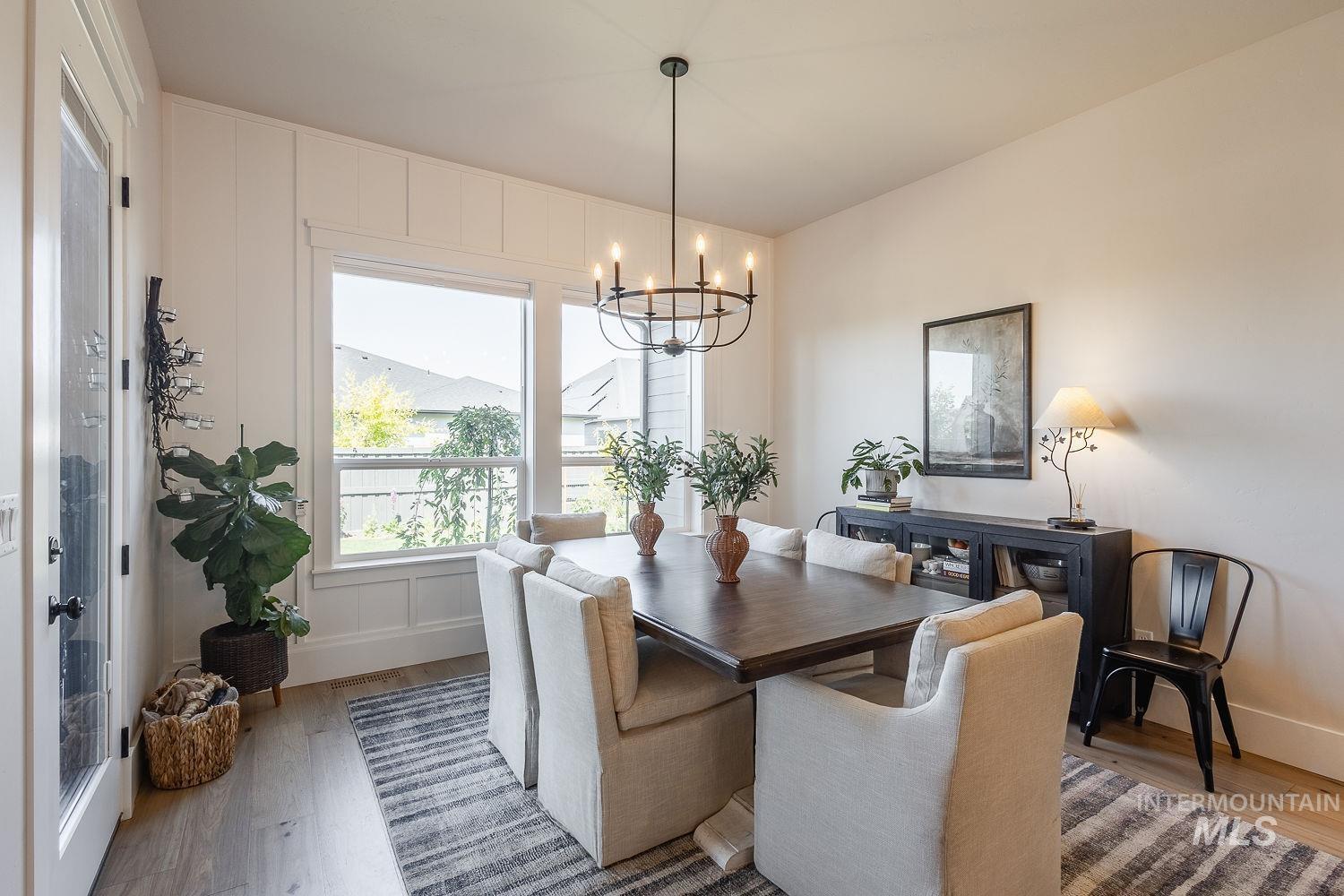 Dining area featuring a chandelier and light wood-style flooring
