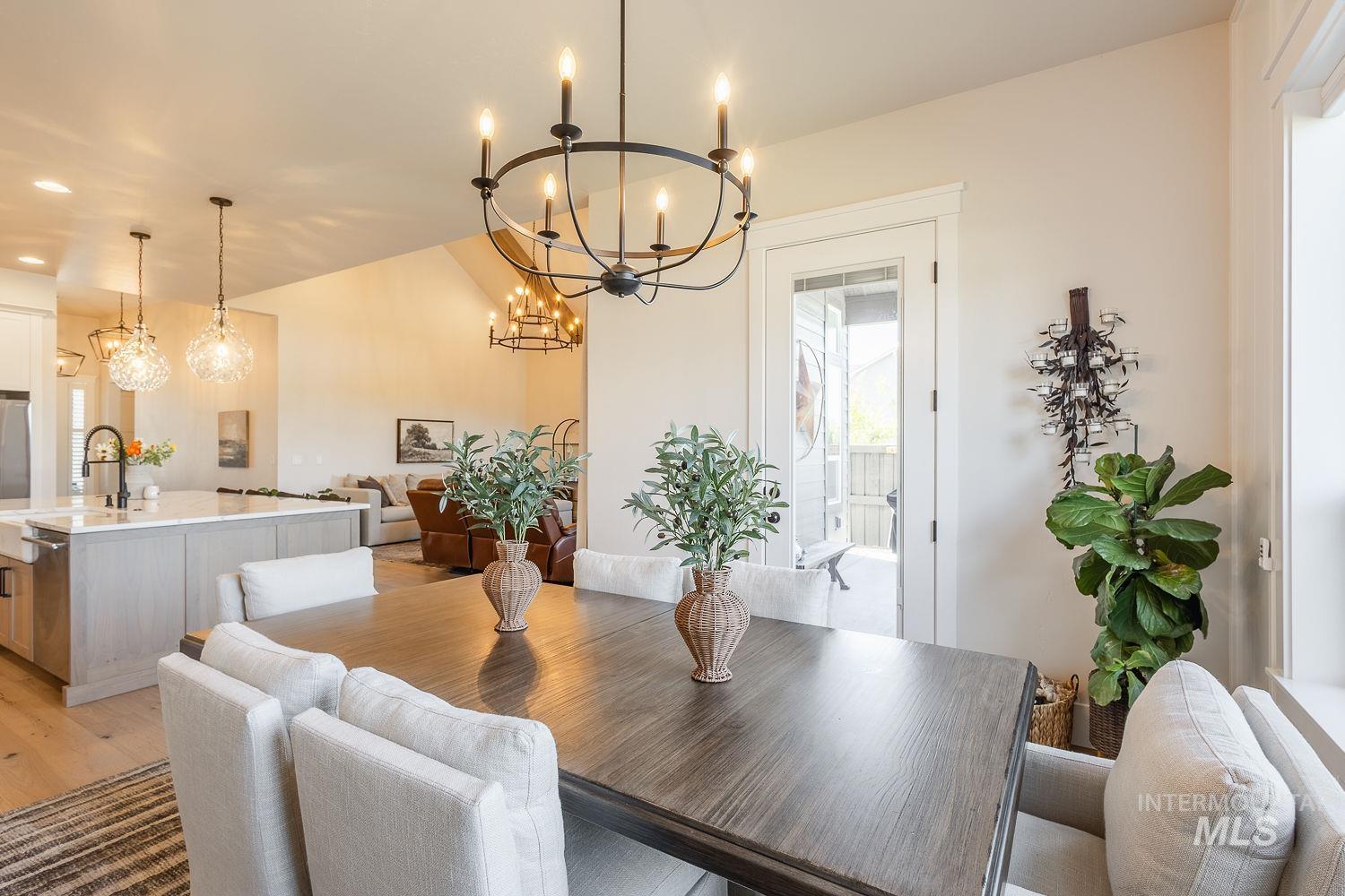 Dining room with a chandelier, light wood-type flooring, and recessed lighting