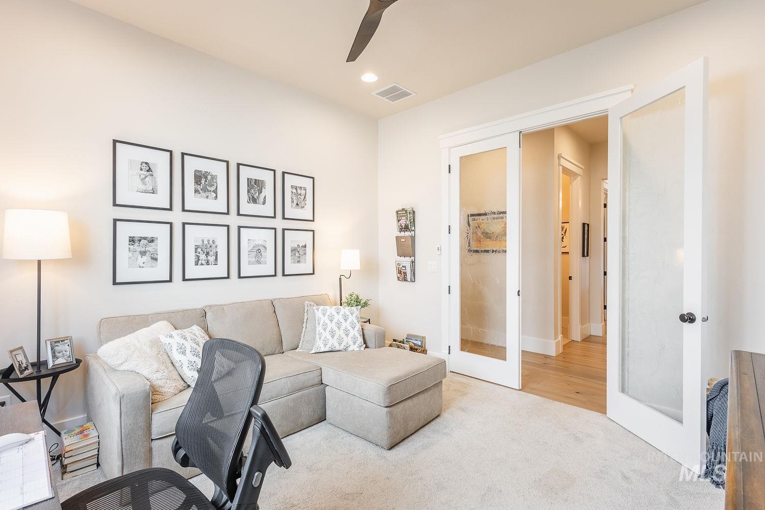 Carpeted living room featuring french doors, a ceiling fan, and recessed lighting