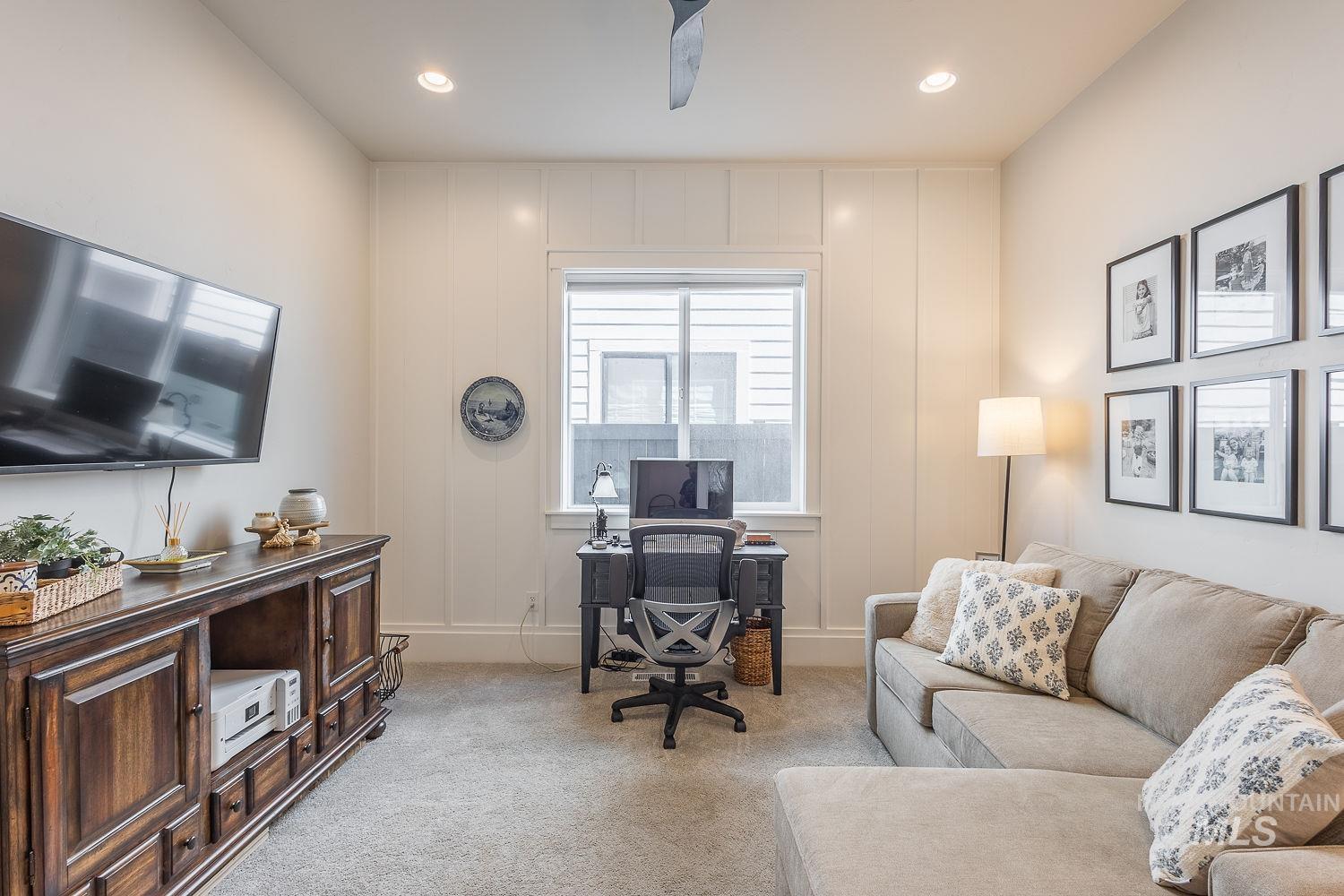 Carpeted home office with recessed lighting
