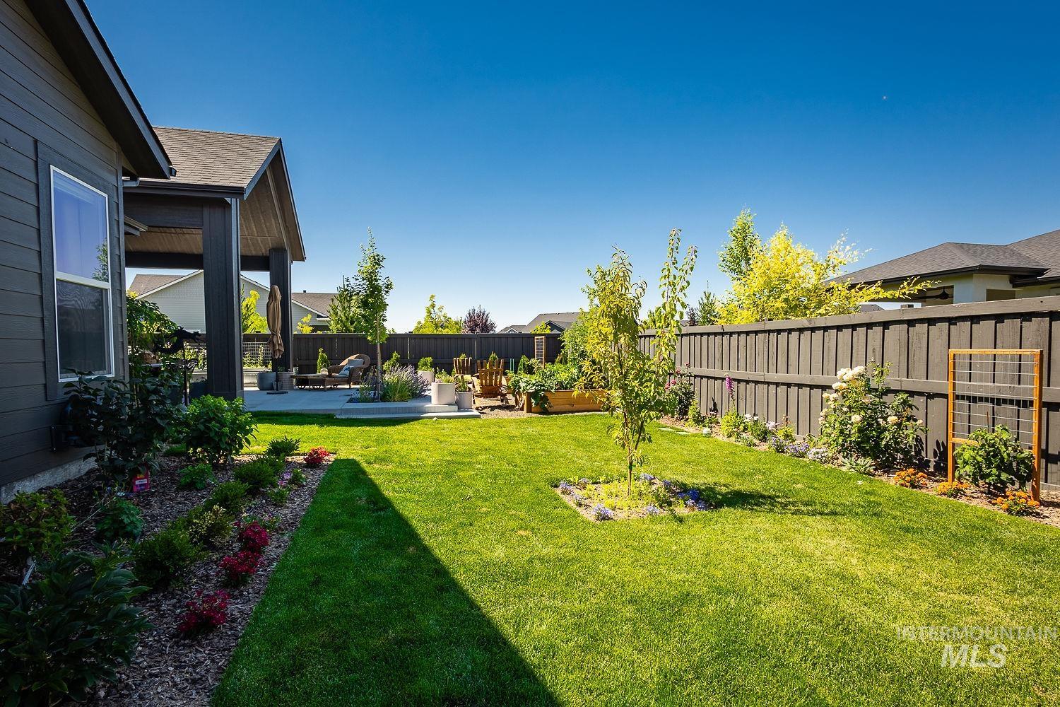 Fenced backyard with a patio