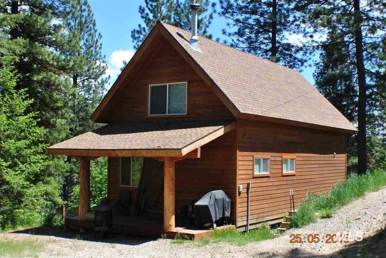 View of property exterior with a shingled roof and covered porch