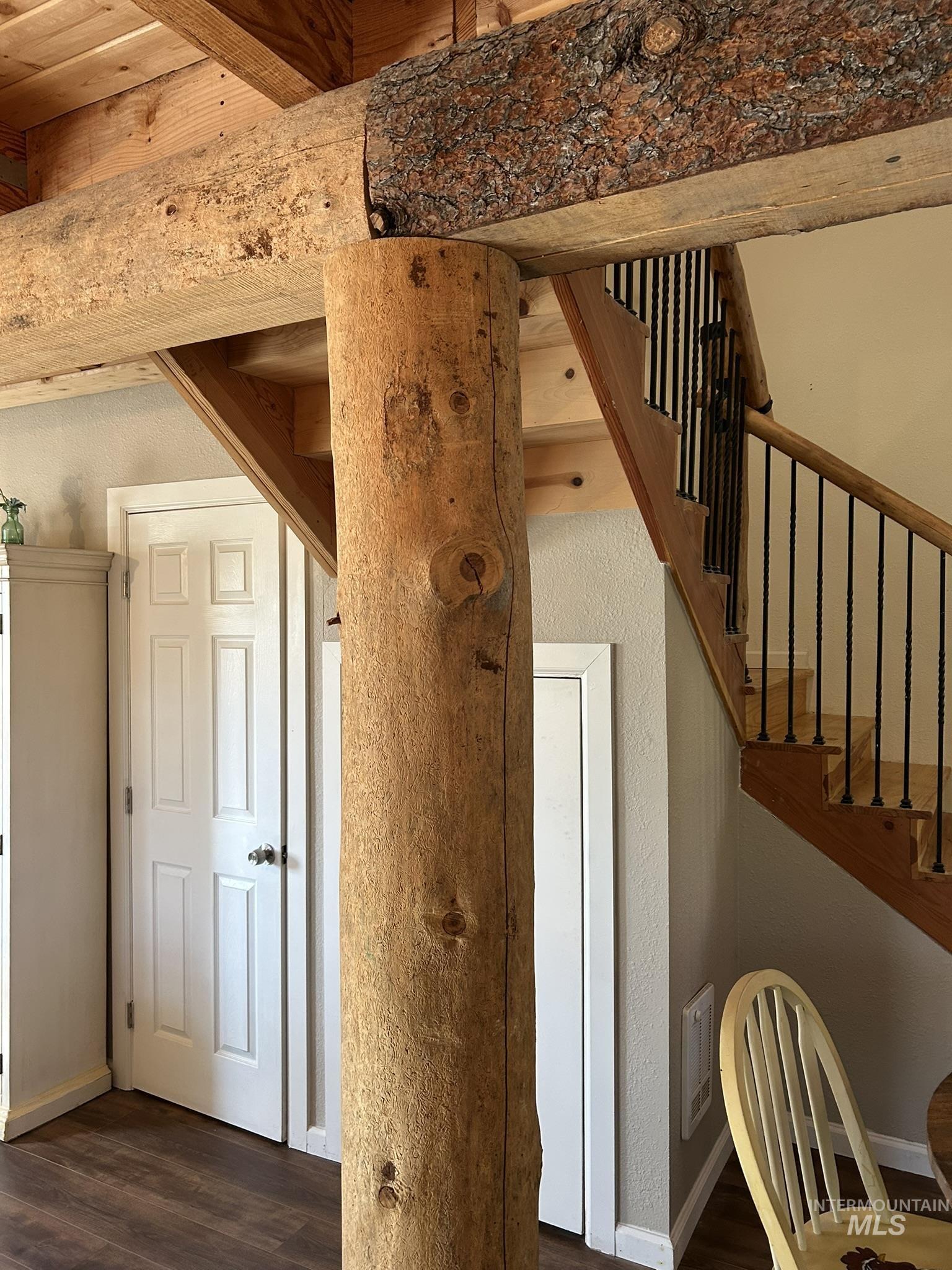 Stairs featuring wood finished floors