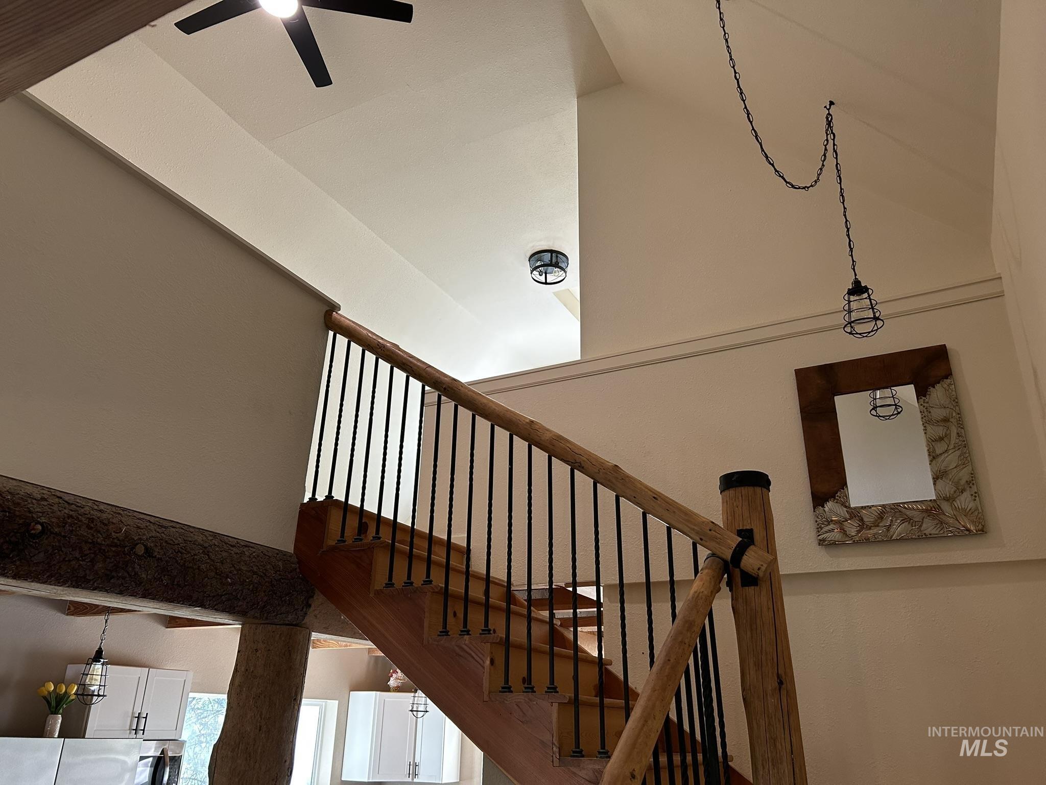 Staircase featuring a ceiling fan