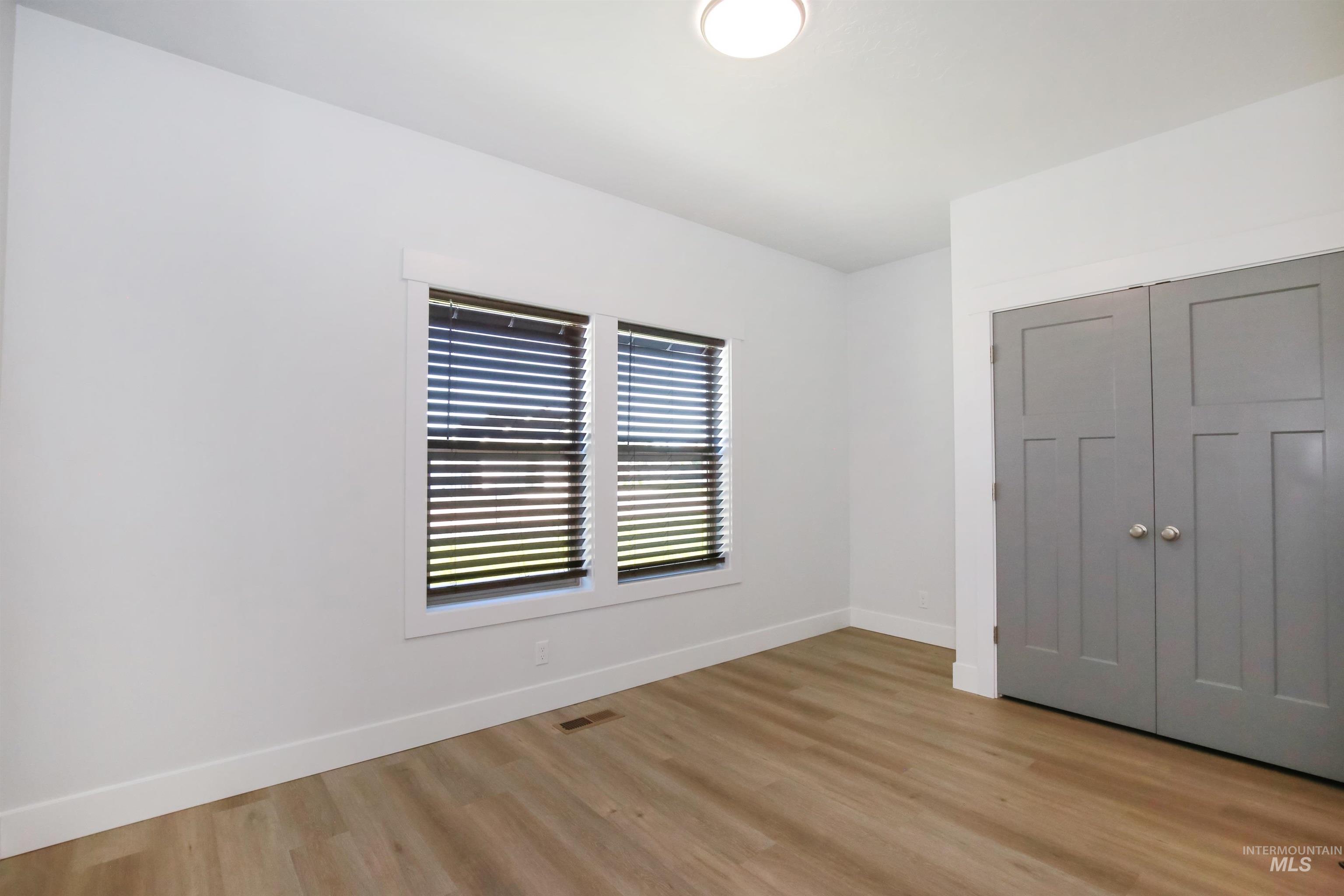 Unfurnished bedroom with a closet and light wood-style flooring