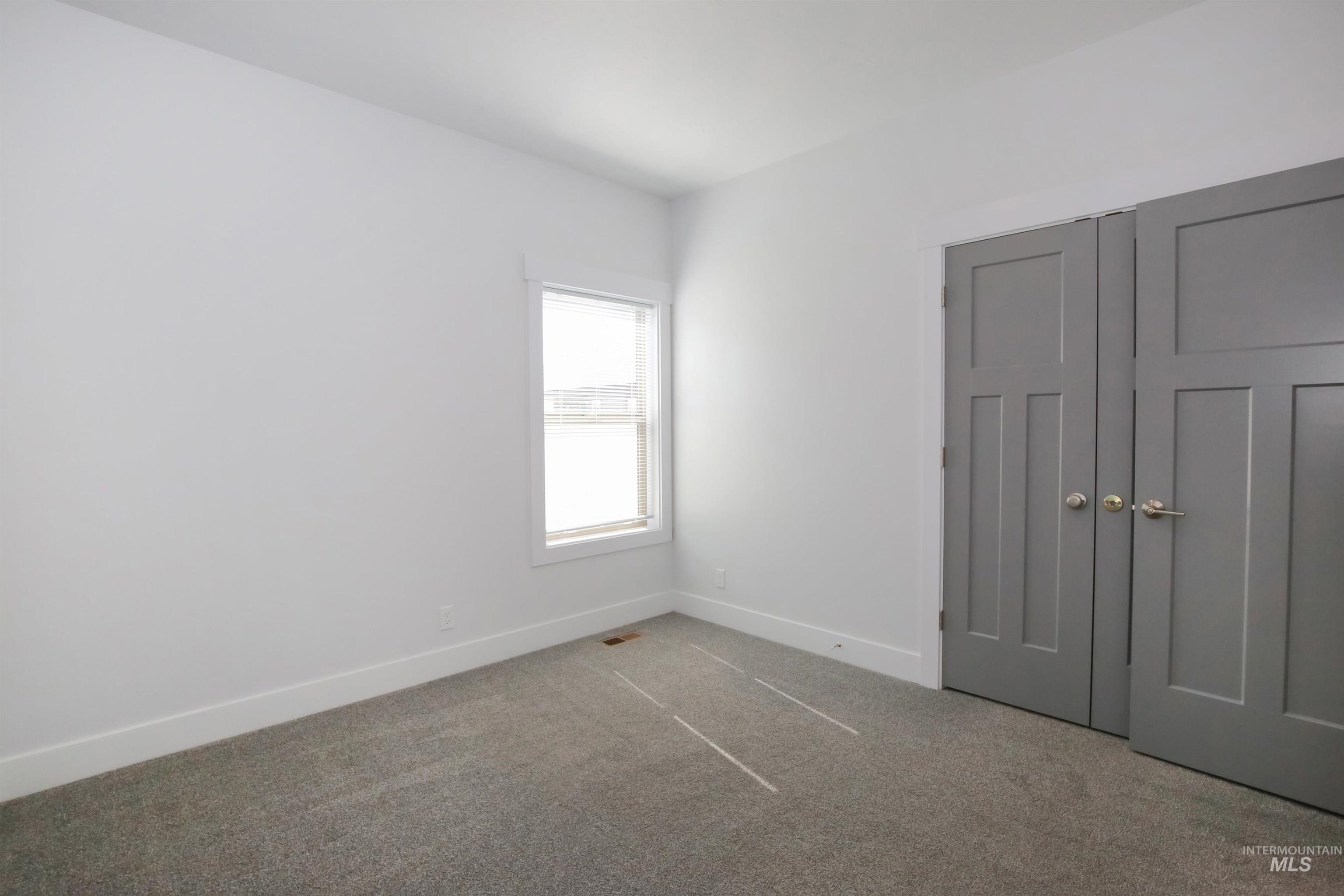 Unfurnished bedroom with carpet floors and a closet