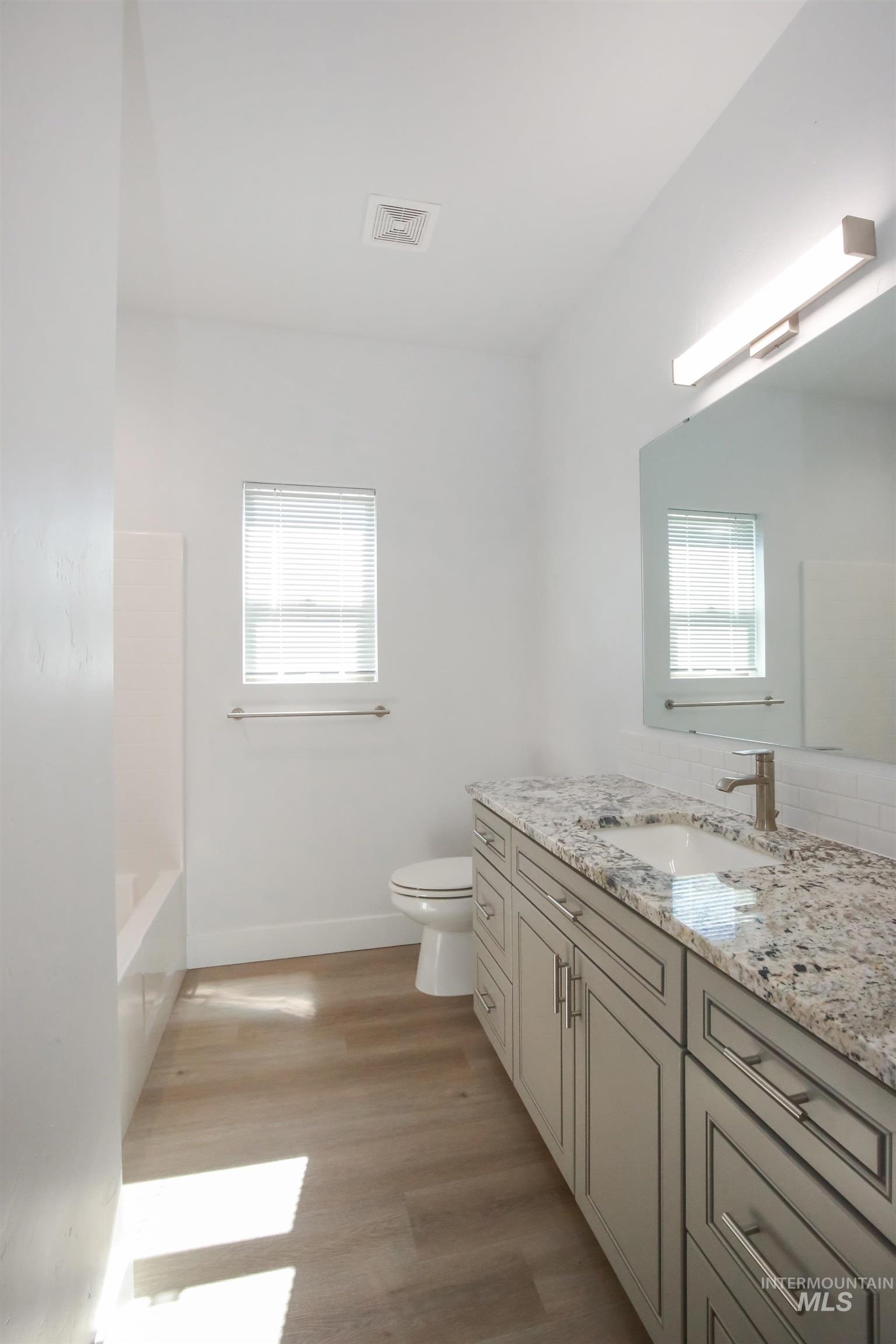 Bathroom with vanity and light wood finished floors