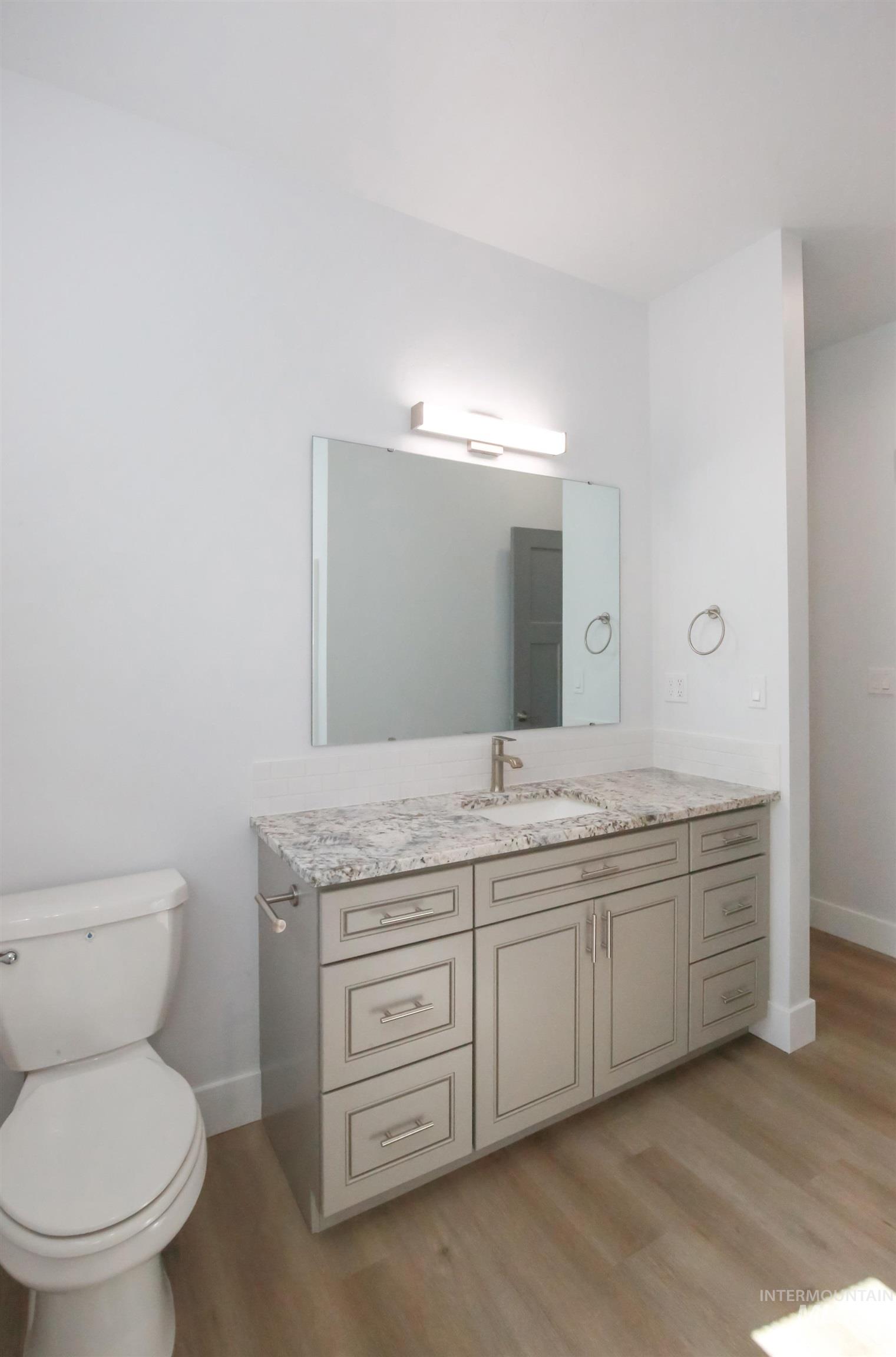 Bathroom with vanity and light wood-style floors