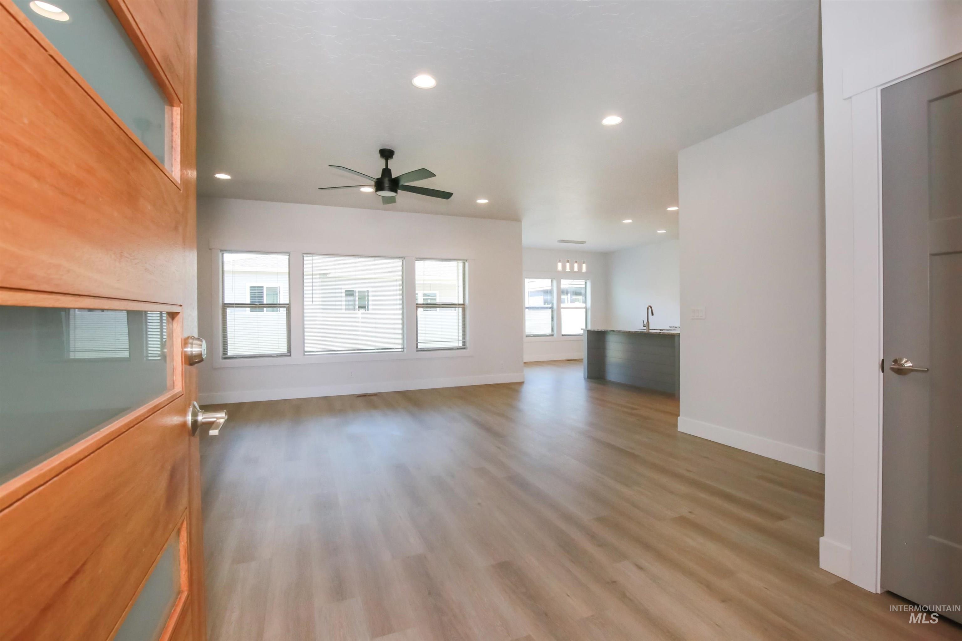 Unfurnished living room featuring recessed lighting, light wood-type flooring, and a ceiling fan