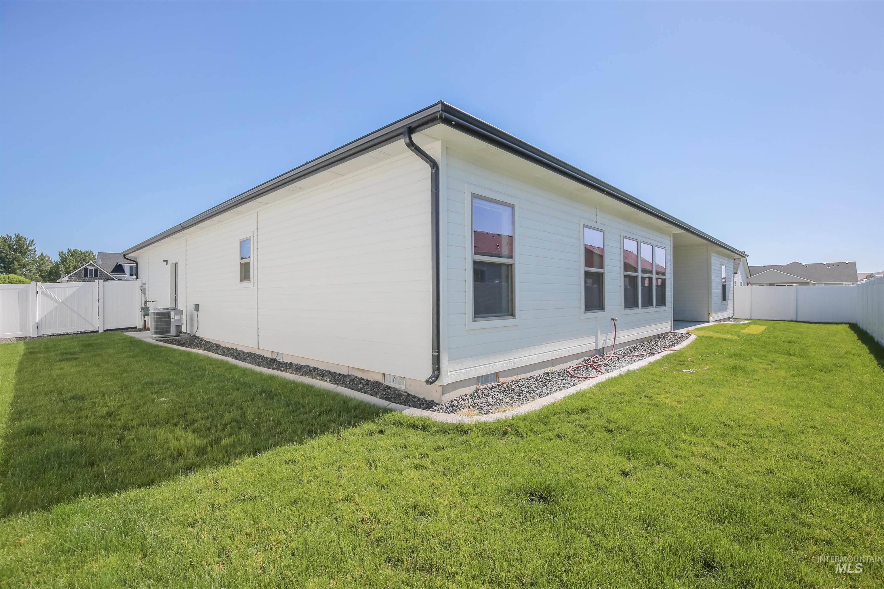 Back of property with a gate and a fenced backyard