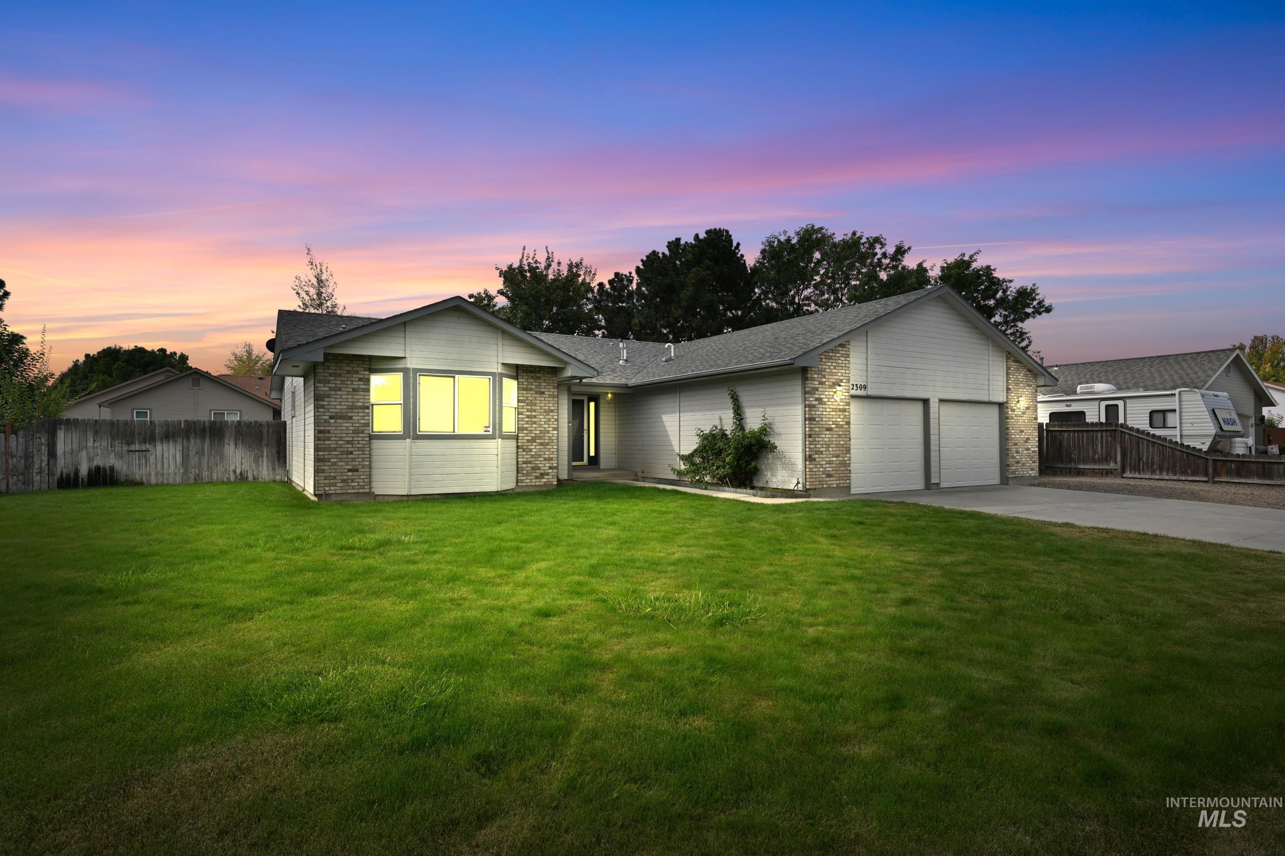 View of front of home with brick siding, a garage, concrete driveway, and a shingled roof