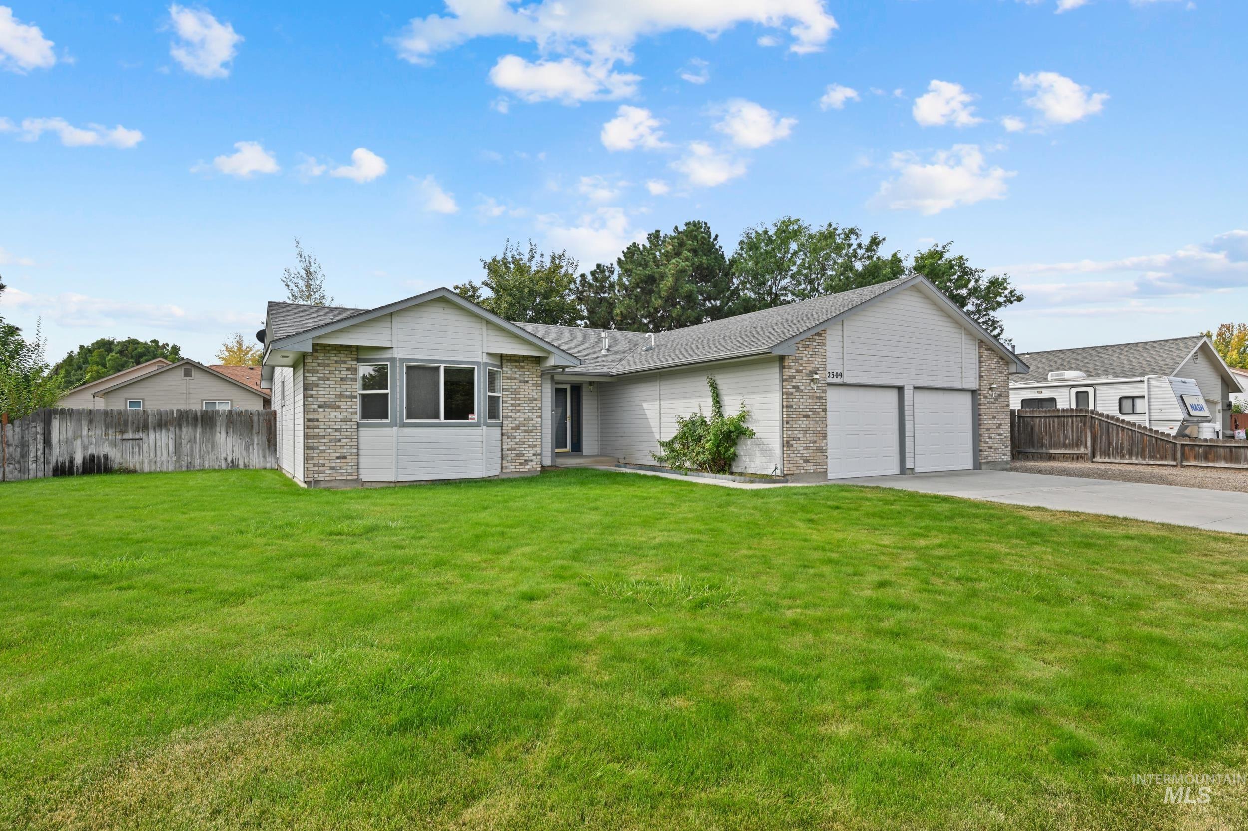 Ranch-style home featuring brick siding, an attached garage, concrete driveway, and a shingled roof