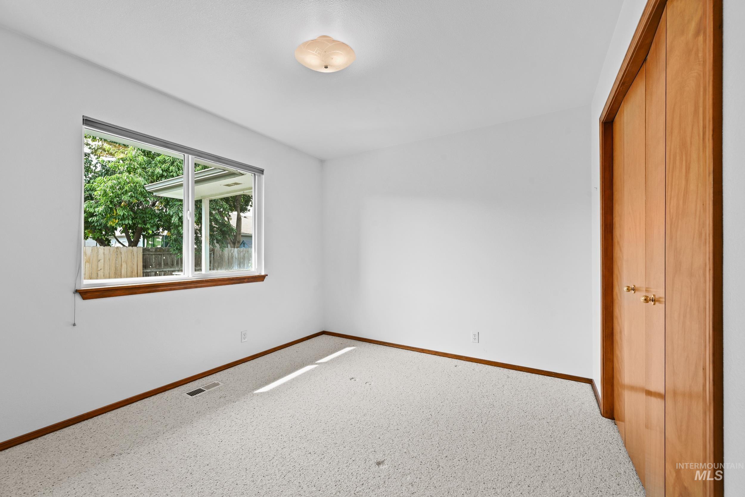 Unfurnished bedroom with a closet and carpet