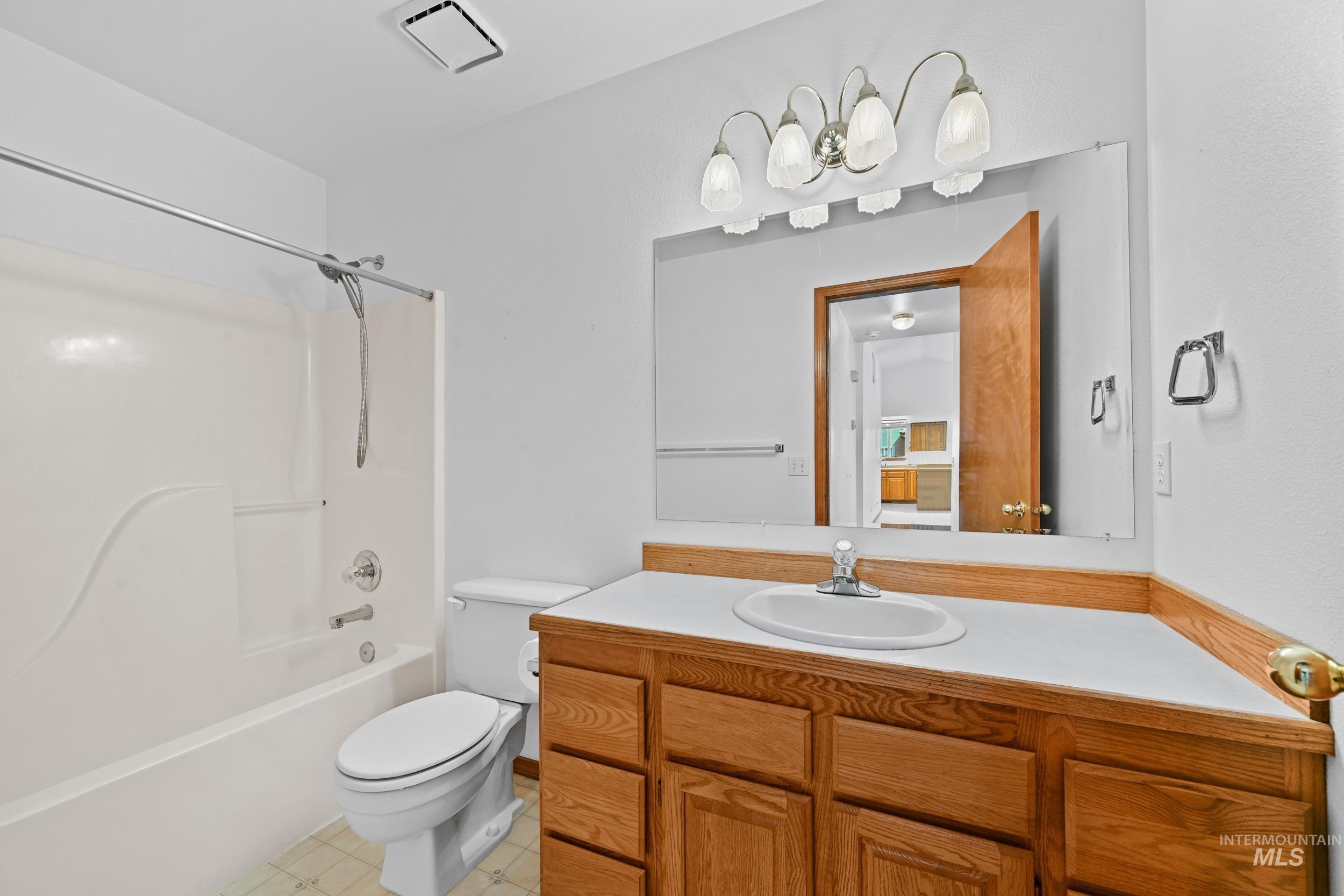 Bathroom featuring  shower combination and vanity